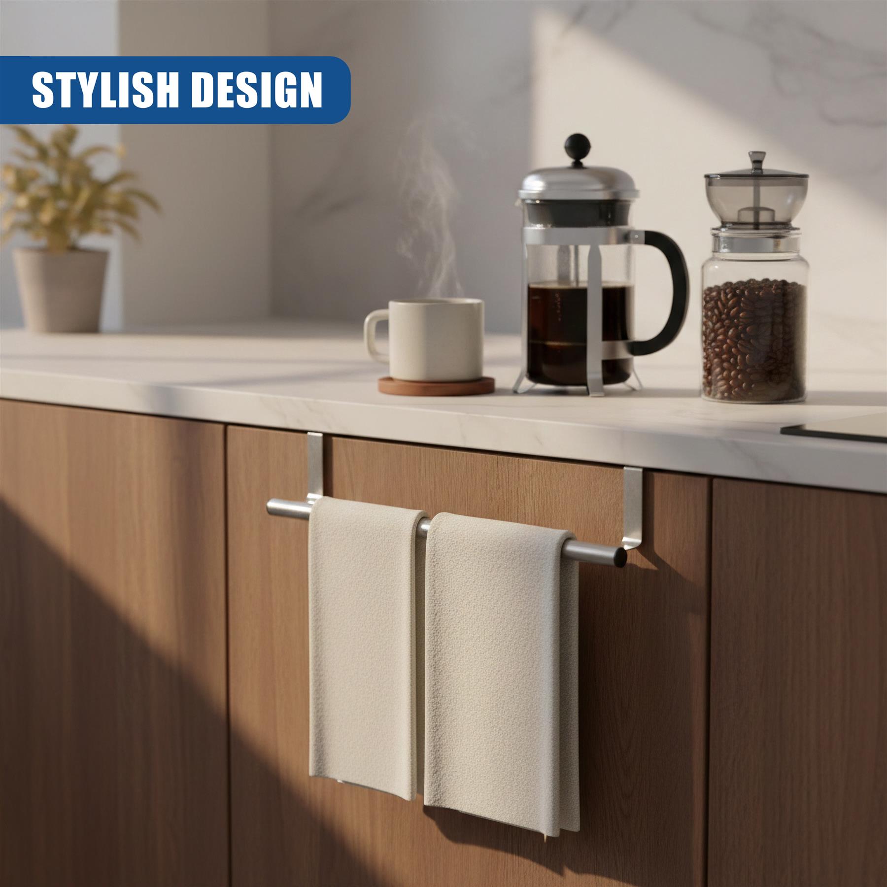 Two folded beige towels hang from a silver metal rail mounted on kitchen cabinetry.