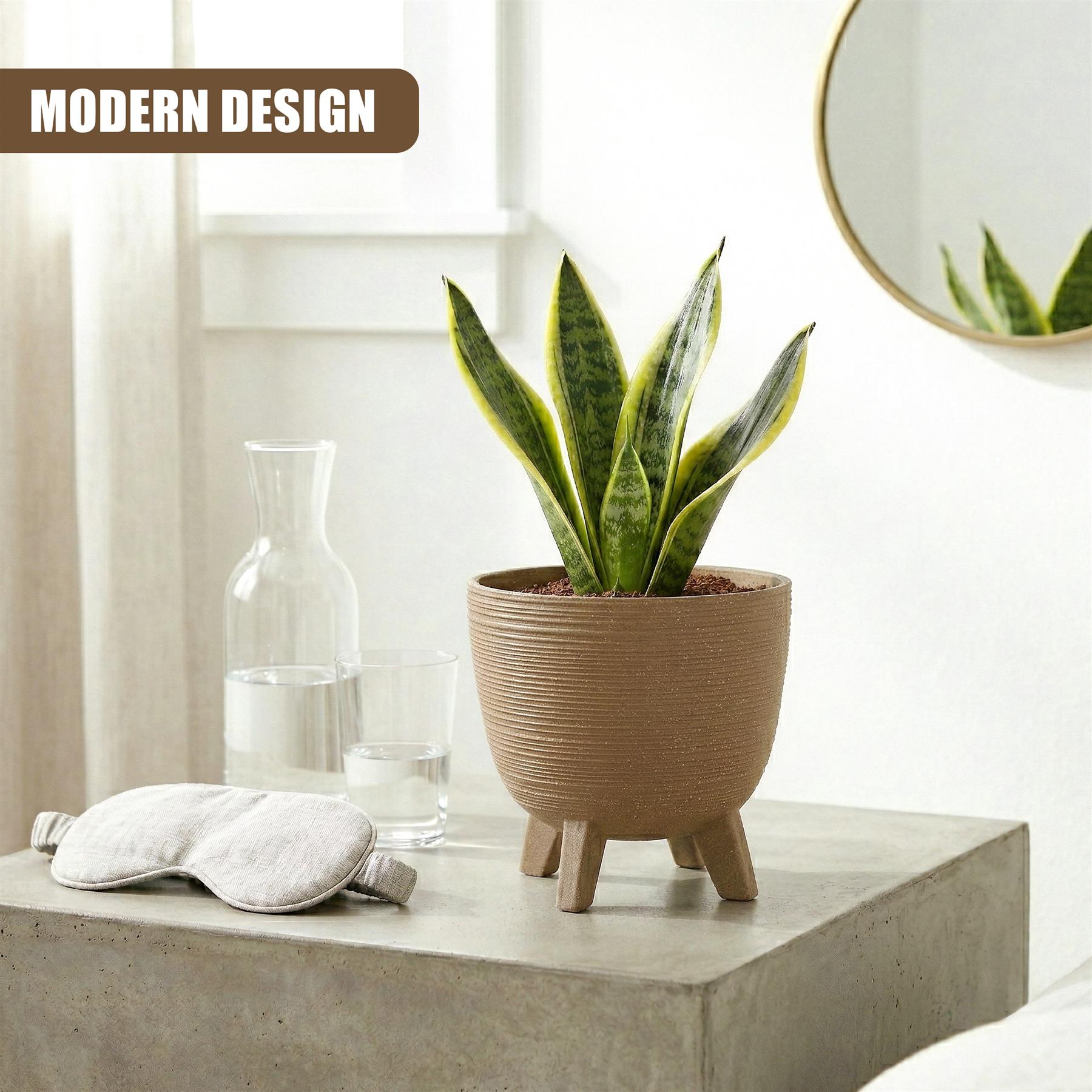 Brown, ribbed flower pot with three legs holding a vibrant green snake plant on a gray surface.