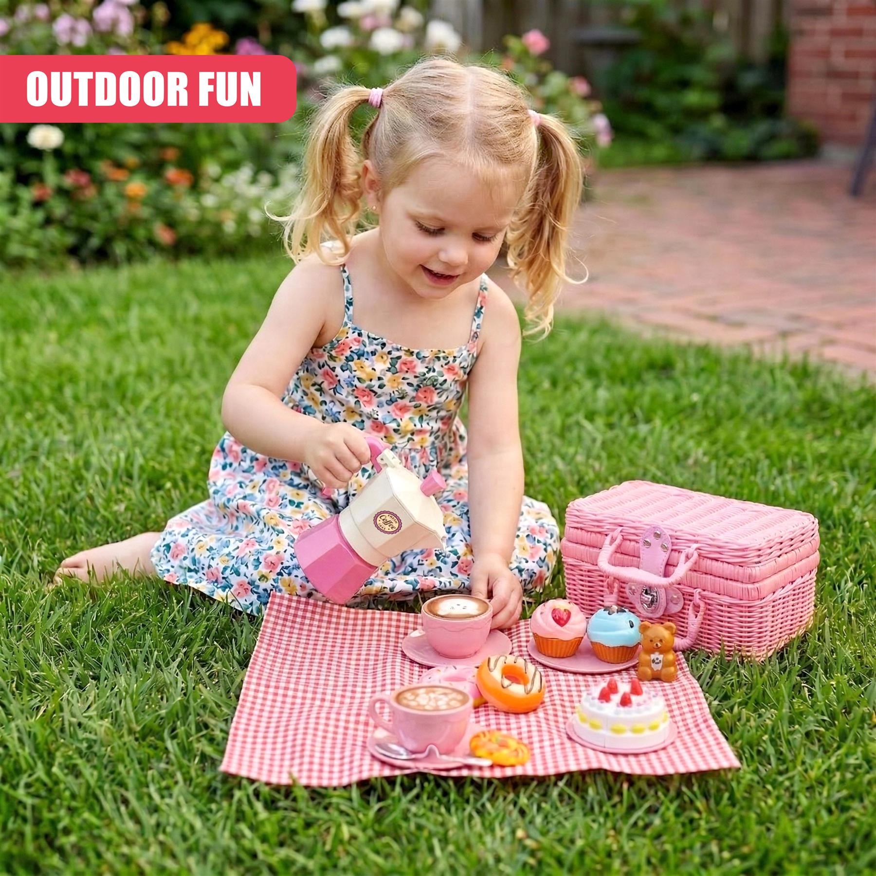 Pink picnic basket, tea set, and snacks arranged on a checkered blanket for outdoor play.