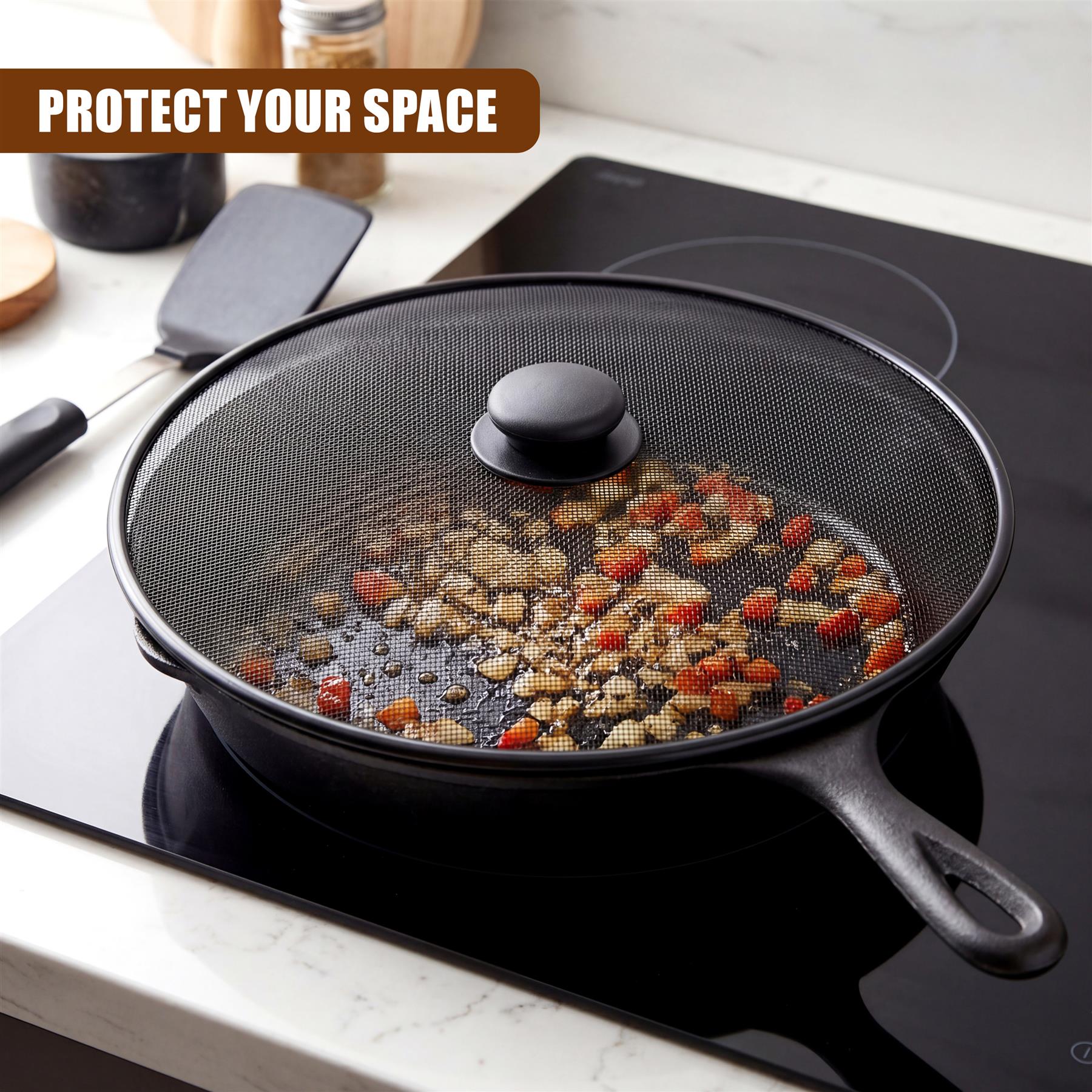 Black mesh splatter screen and handle rest on a cooktop, containing food debris.