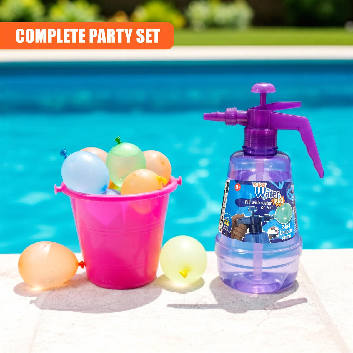 A purple 2 in 1 air & water balloon pump sits with 100 balloons and a pink bucket by a swimming pool