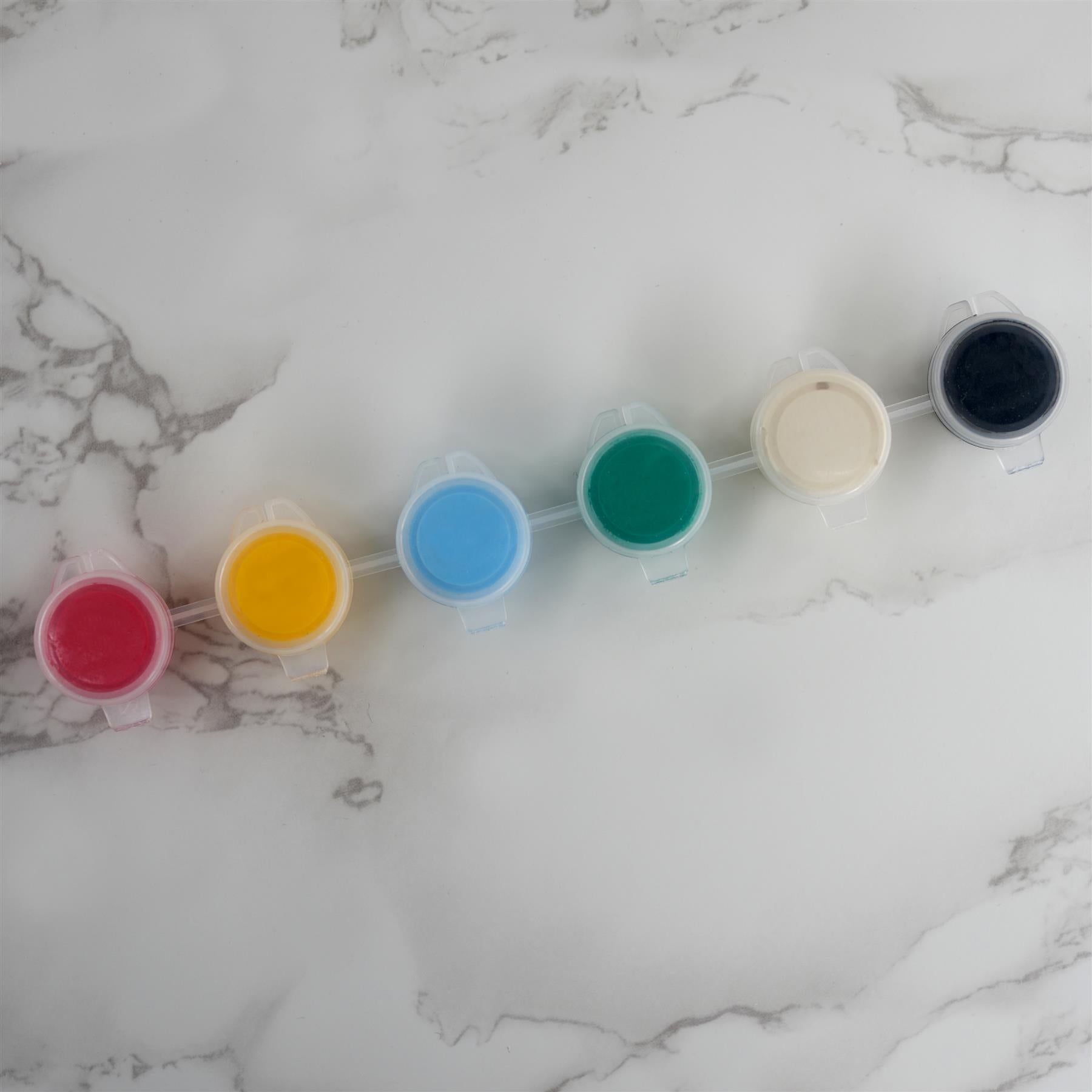 Six colored samples, including red, yellow, blue, green, beige, and black, displayed on a marbled surface.