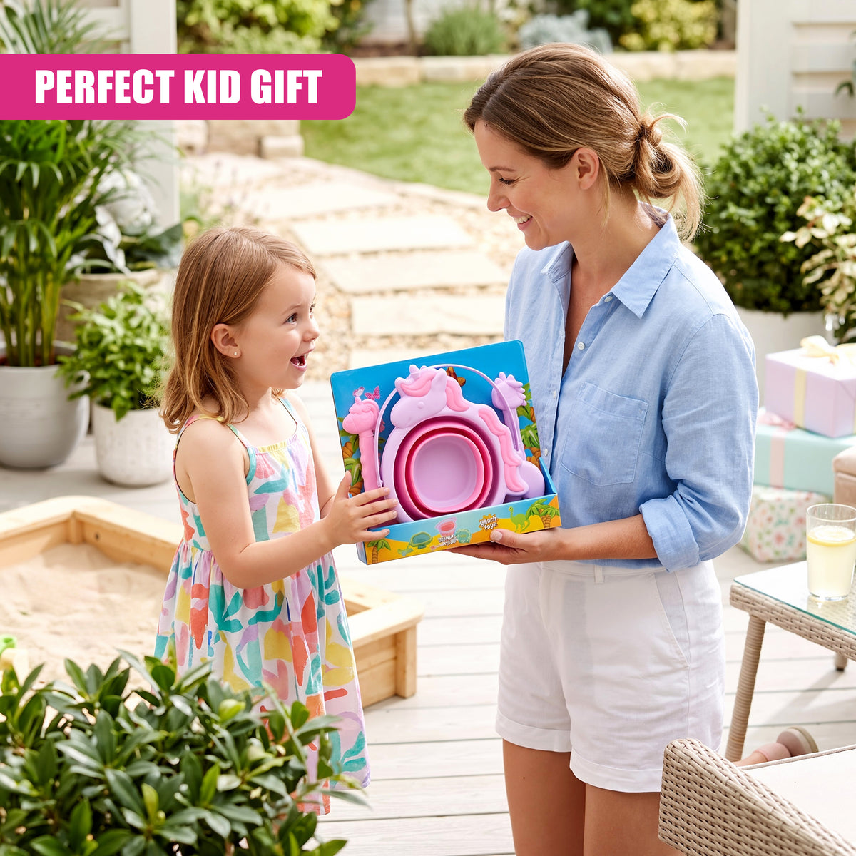 A mother presents a pink and blue collapsible bucket and spade set to a smiling young girl outdoors