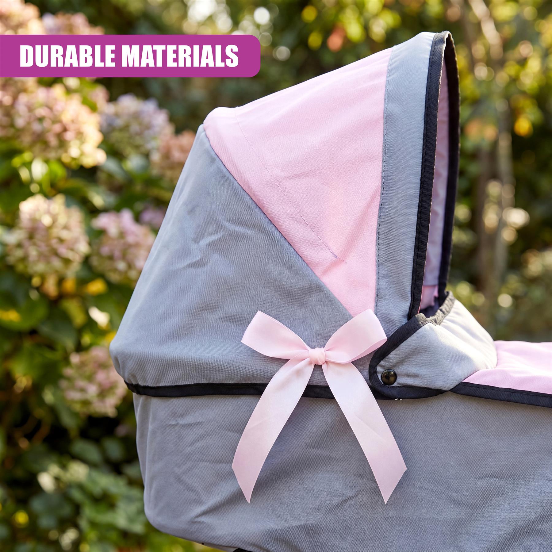 Pink and gray doll's pram canopy featuring black trim and a decorative light pink ribbon bow.