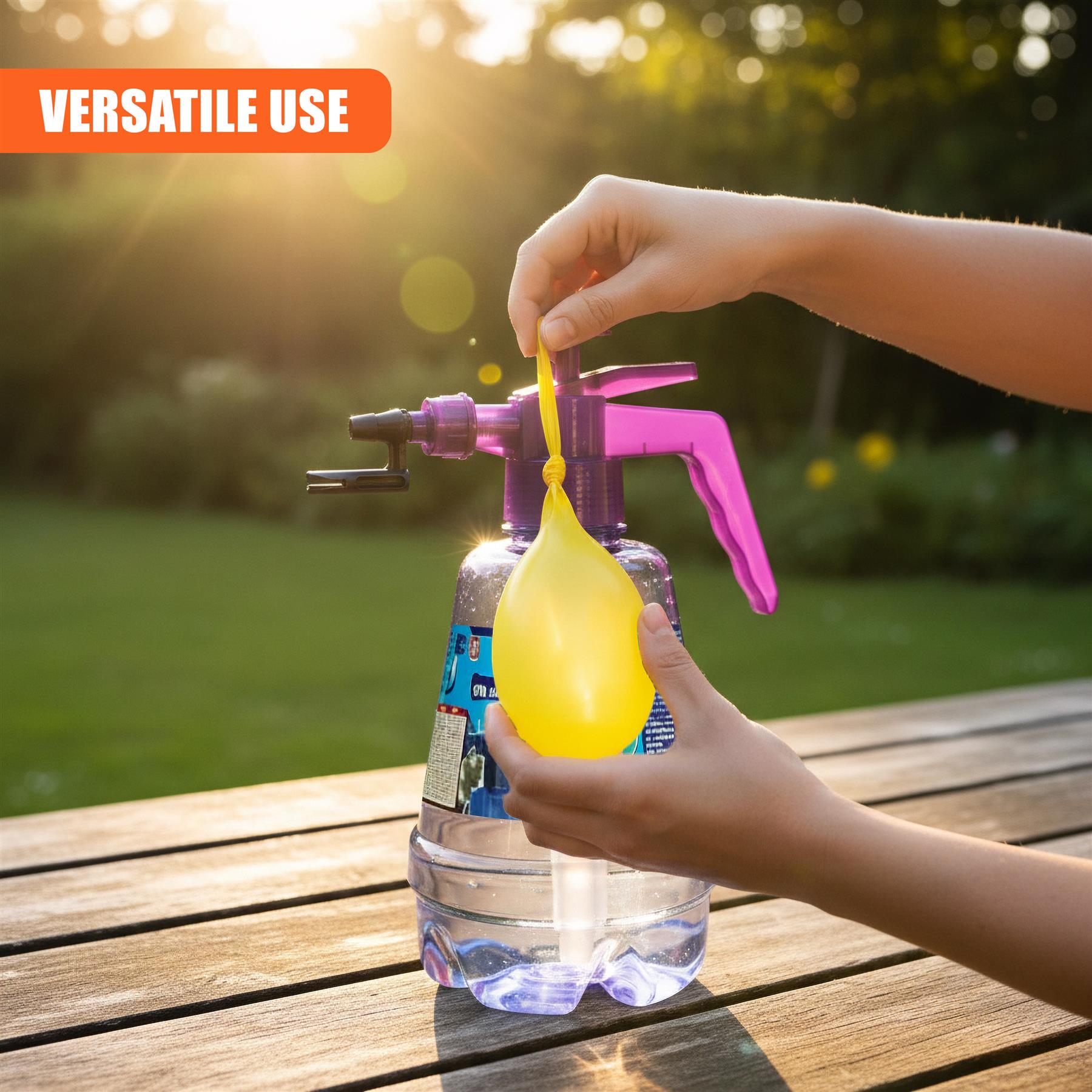 A hand uses a bright plastic device to launch a balloon into water contained within a clear cup.