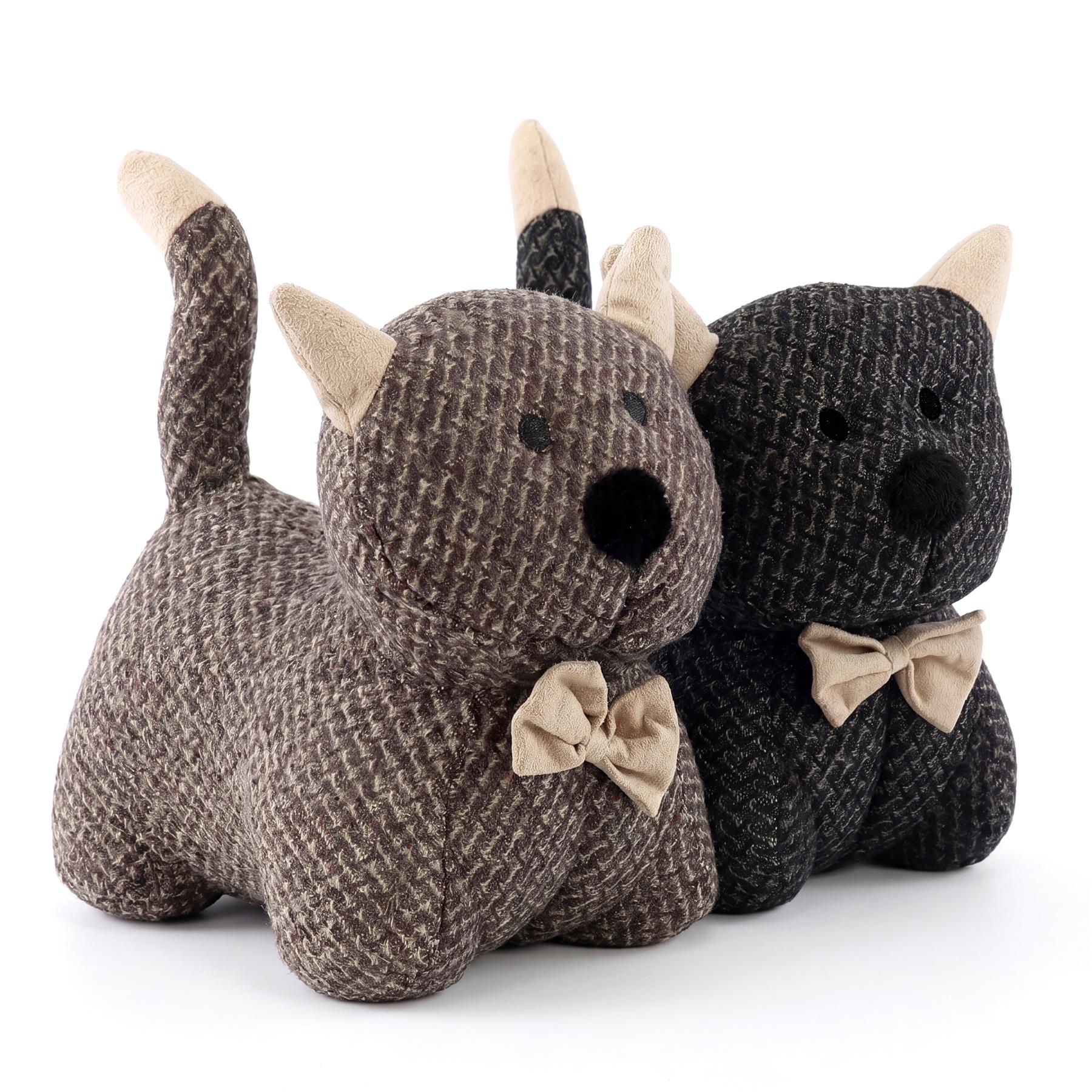 A grouping of three plush toys, including a puppy, a horned animal, and a black bear.