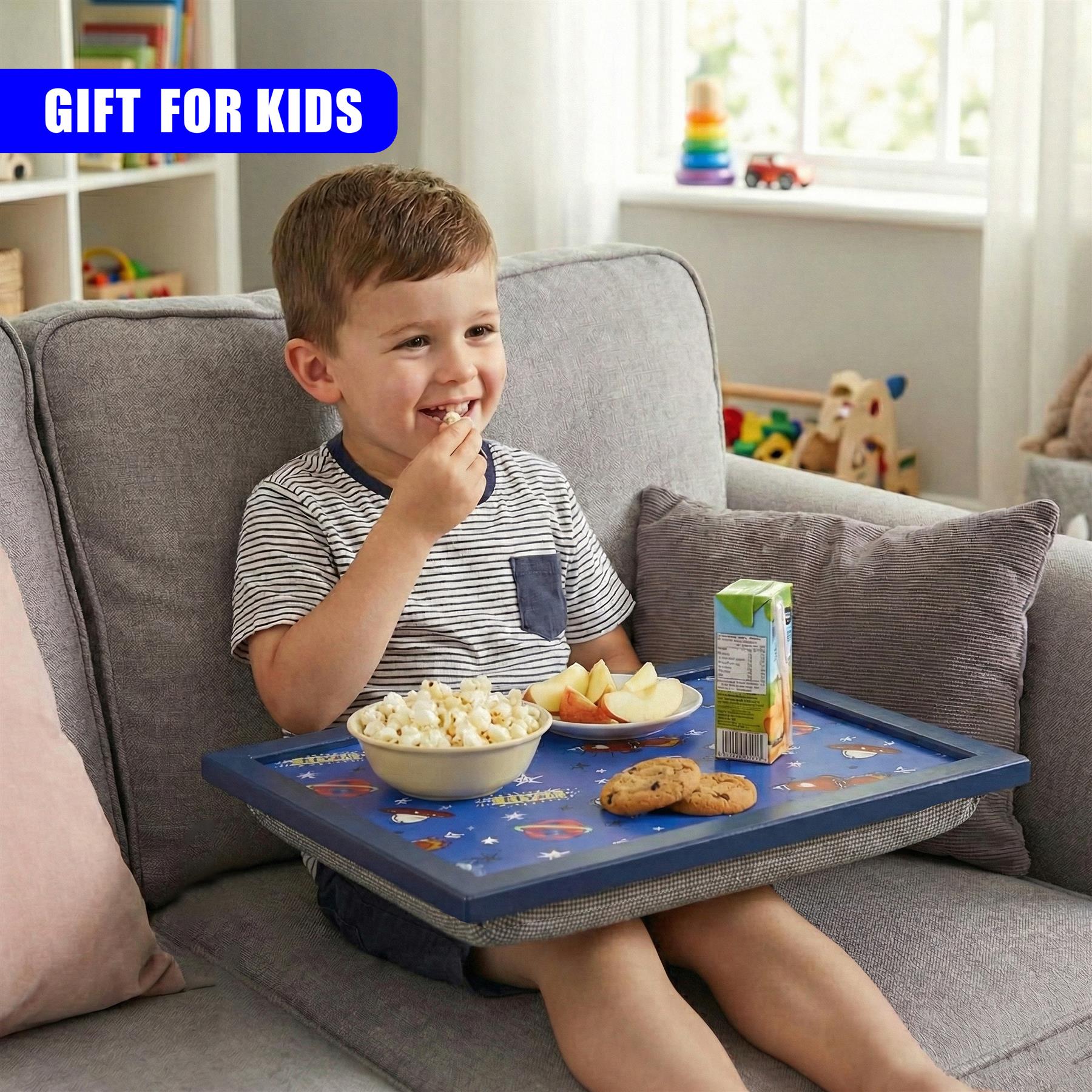 Young boy enjoying snacks from a blue lap tray while sitting on a couch.