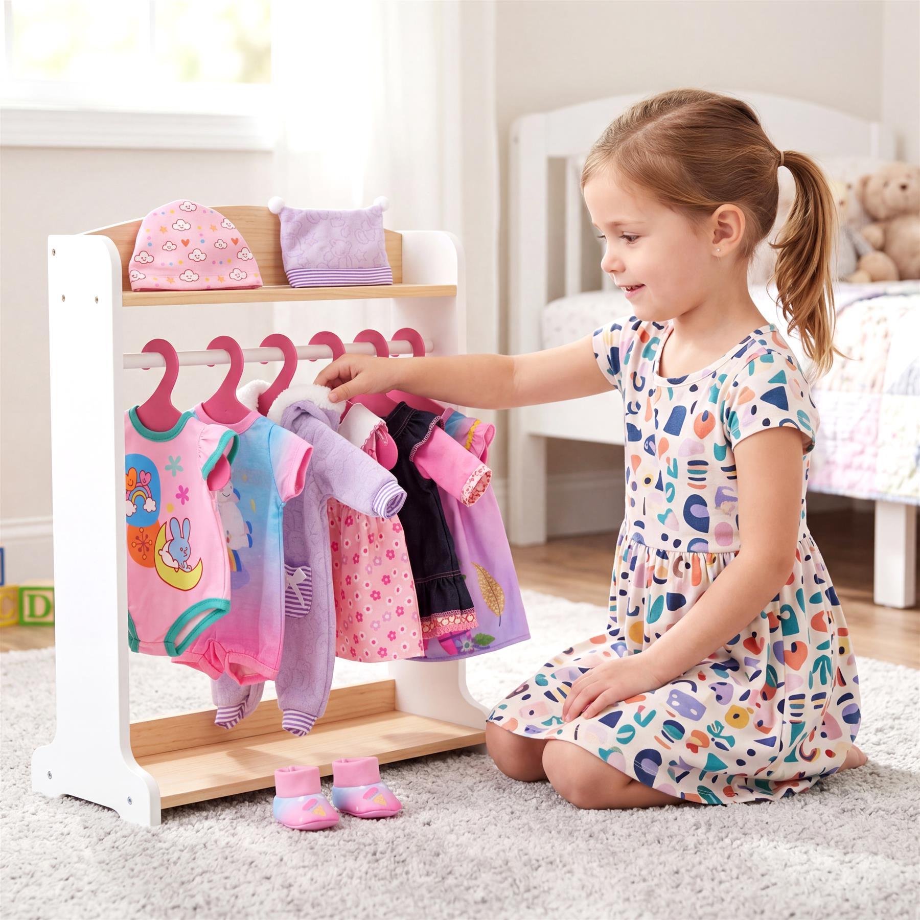 A young girl selects colorful doll clothes from a white display rack near a child's bed.