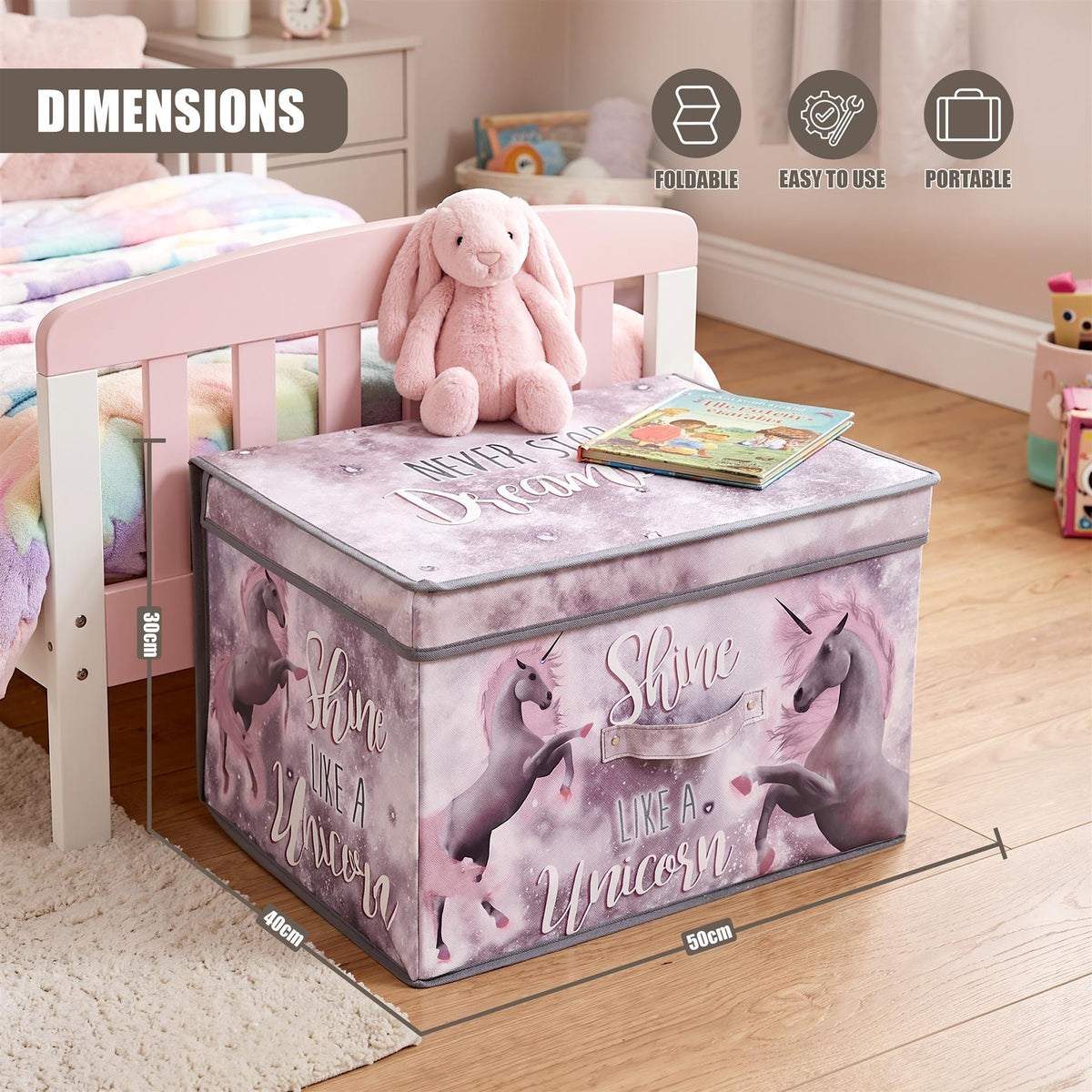 Unicorns large storage box with a unicorn design sits on a bed beside a toy
