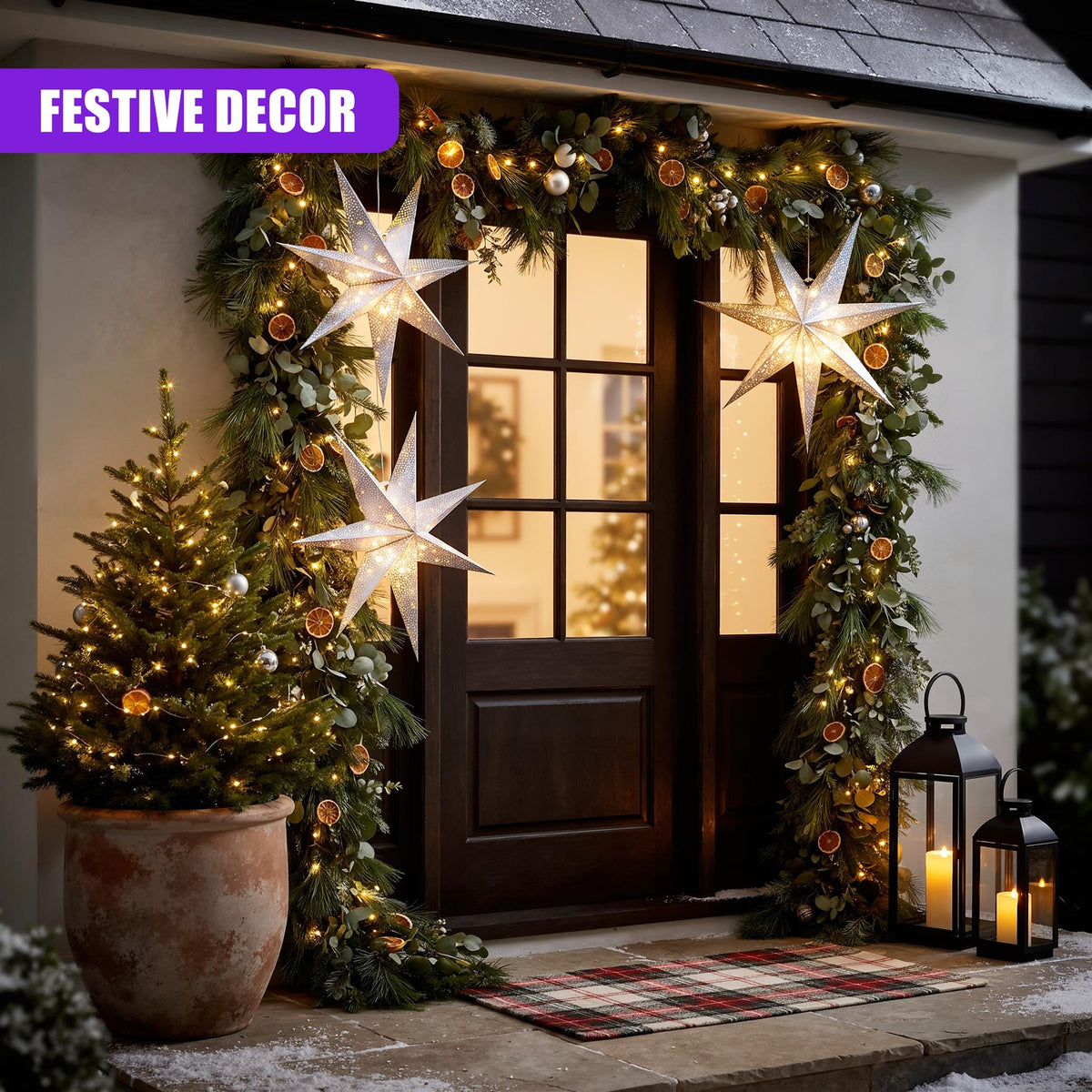 A festive doorway decorated with a large silver LED paper star lantern and winter greenery