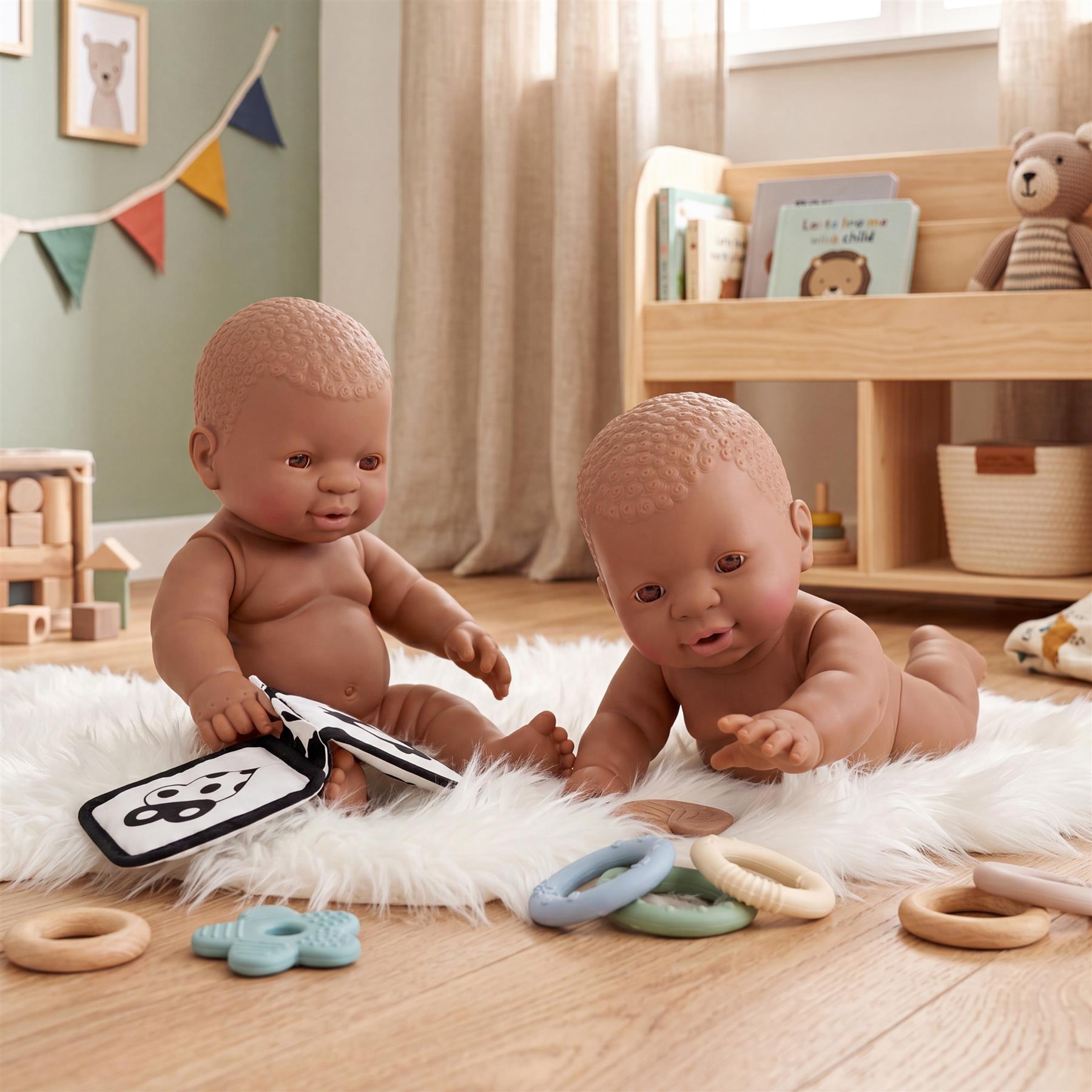 Two matching black twin dolls, each measuring twelve inches tall, are displayed together.