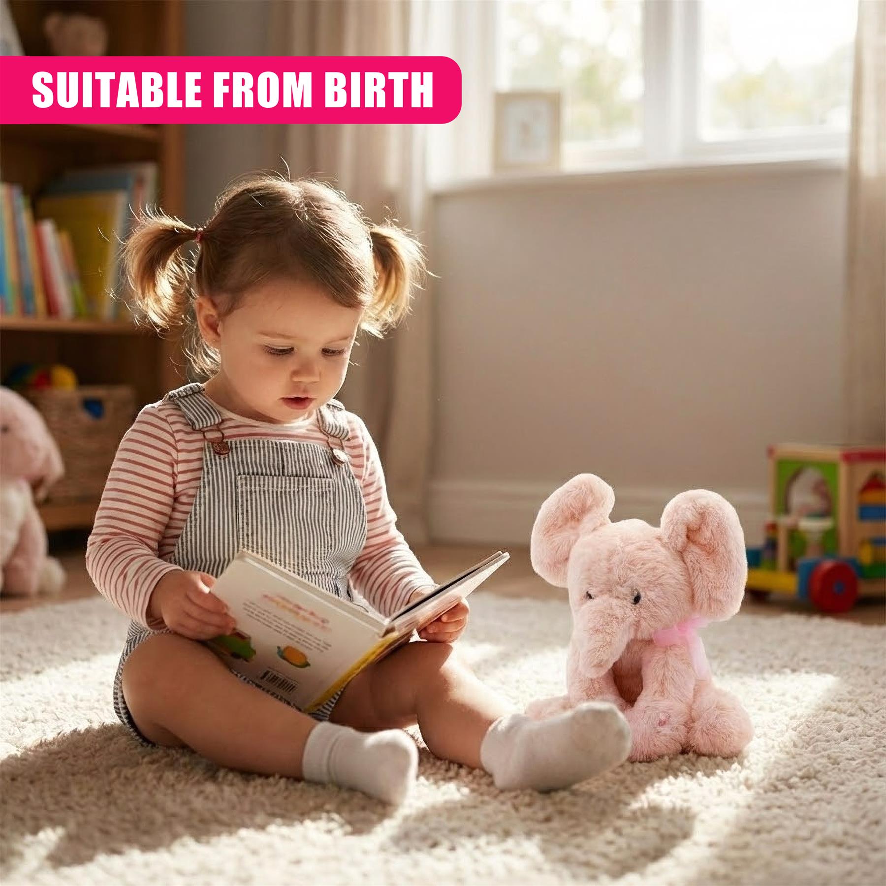 A girl reads a book while a plush pink elephant toy sits beside her on a rug.