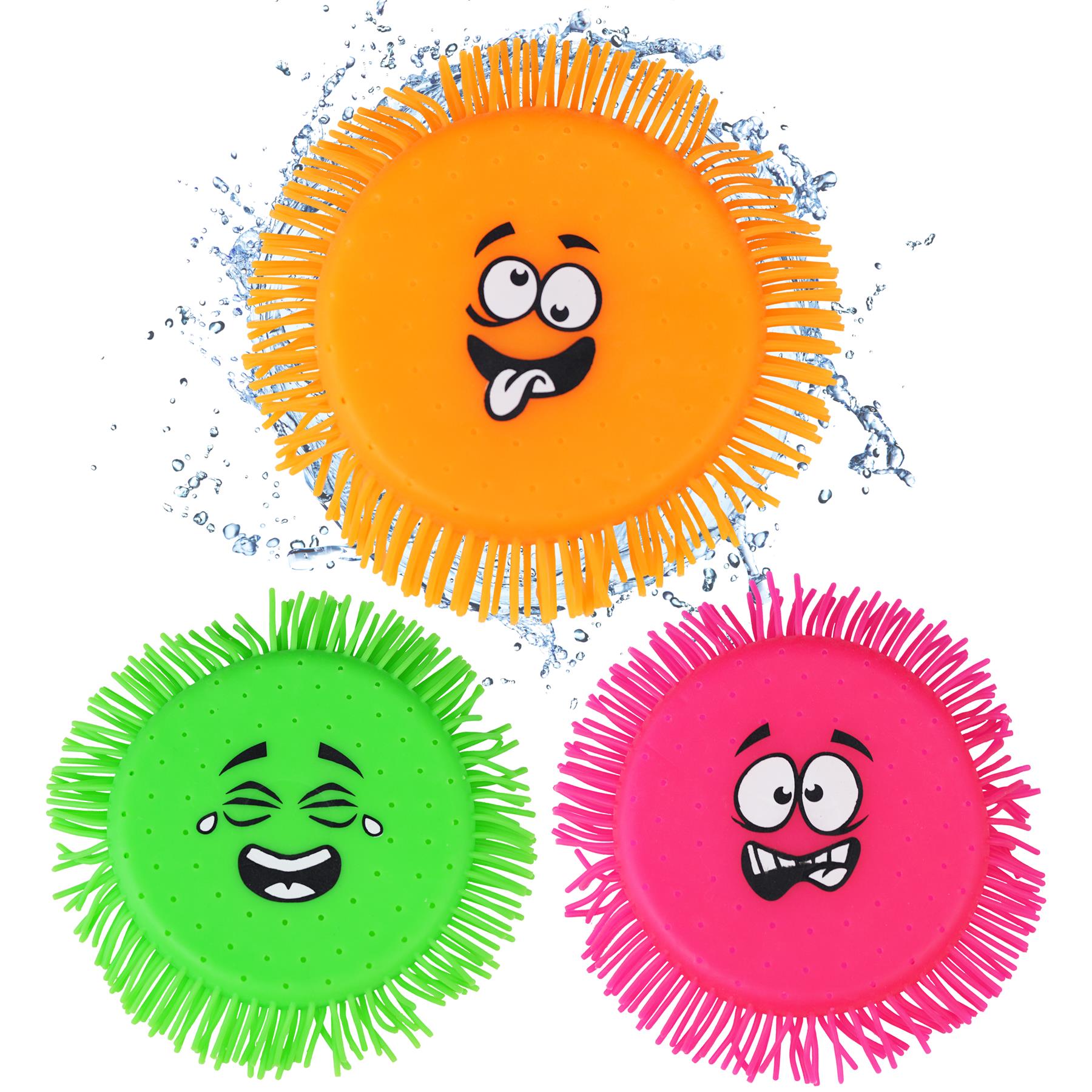 This image displays four water absorbing flying disc toys with cartoon faces. They are neon-colored, featuring a yellow, pink, green, and orange design with playful facial expressions and are placed on a white surface. The toys appear to be floating due to their water absorption properties.