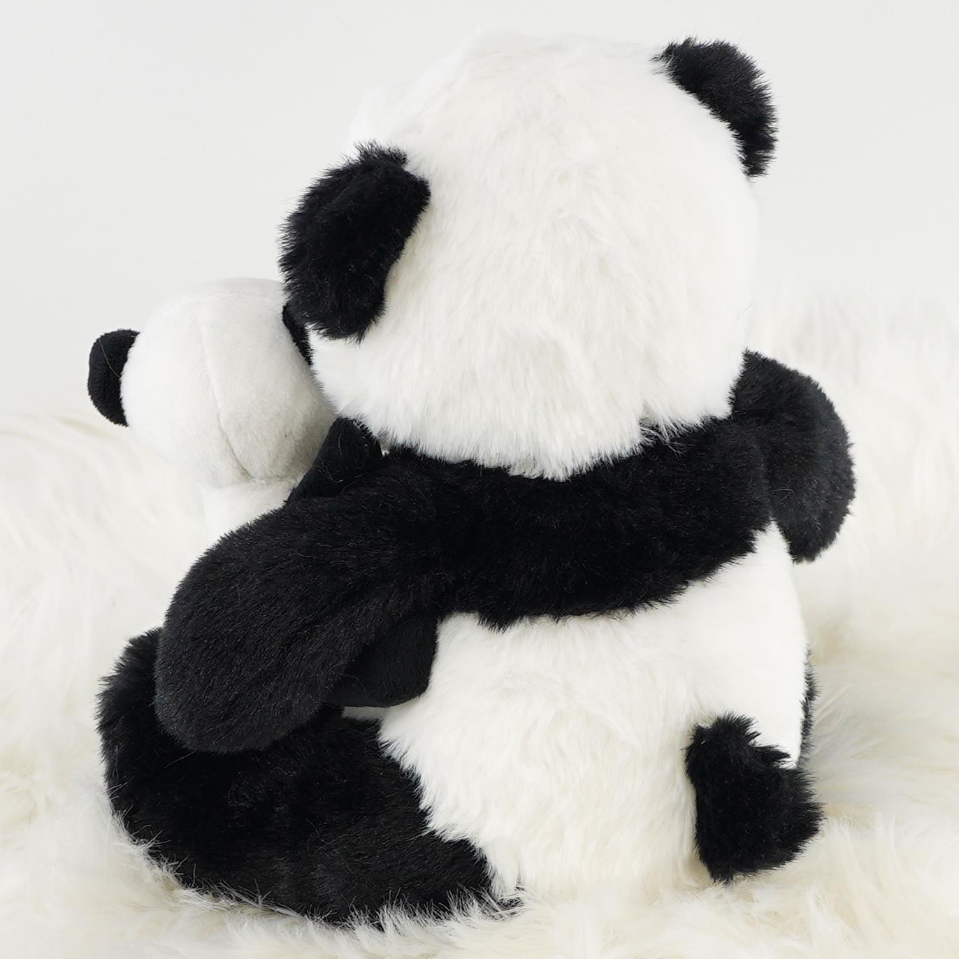 A super soft plush toy set featuring a mommy panda hugging her baby panda, both in classic black and white colors, resting on a fluffy white surface. Ideal for cuddling, gifting, or decorative purposes. Perfect for kids and panda lovers. Available at themagictoyshop.