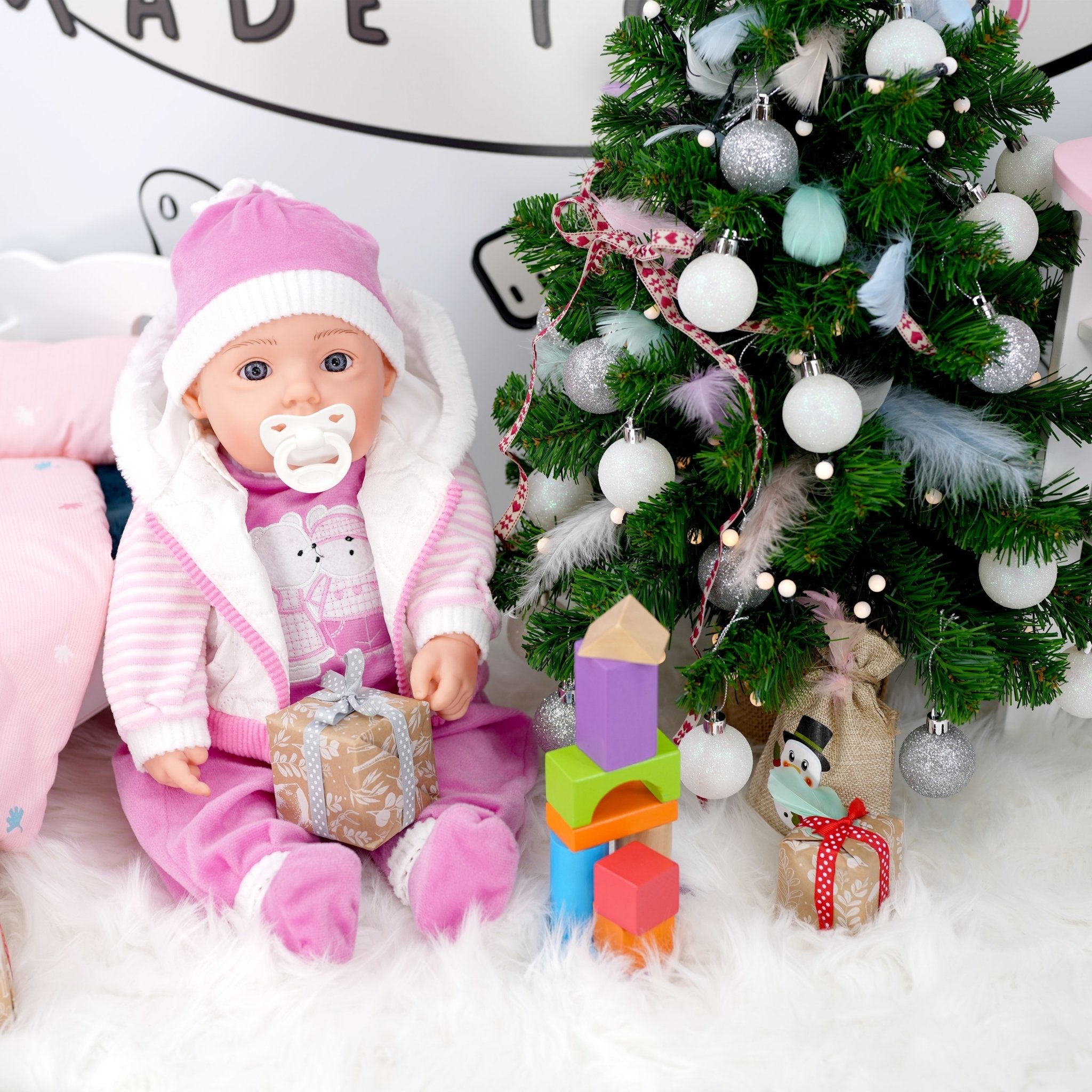 Pink baby doll with Christmas decorations - The Magic Toy Shop