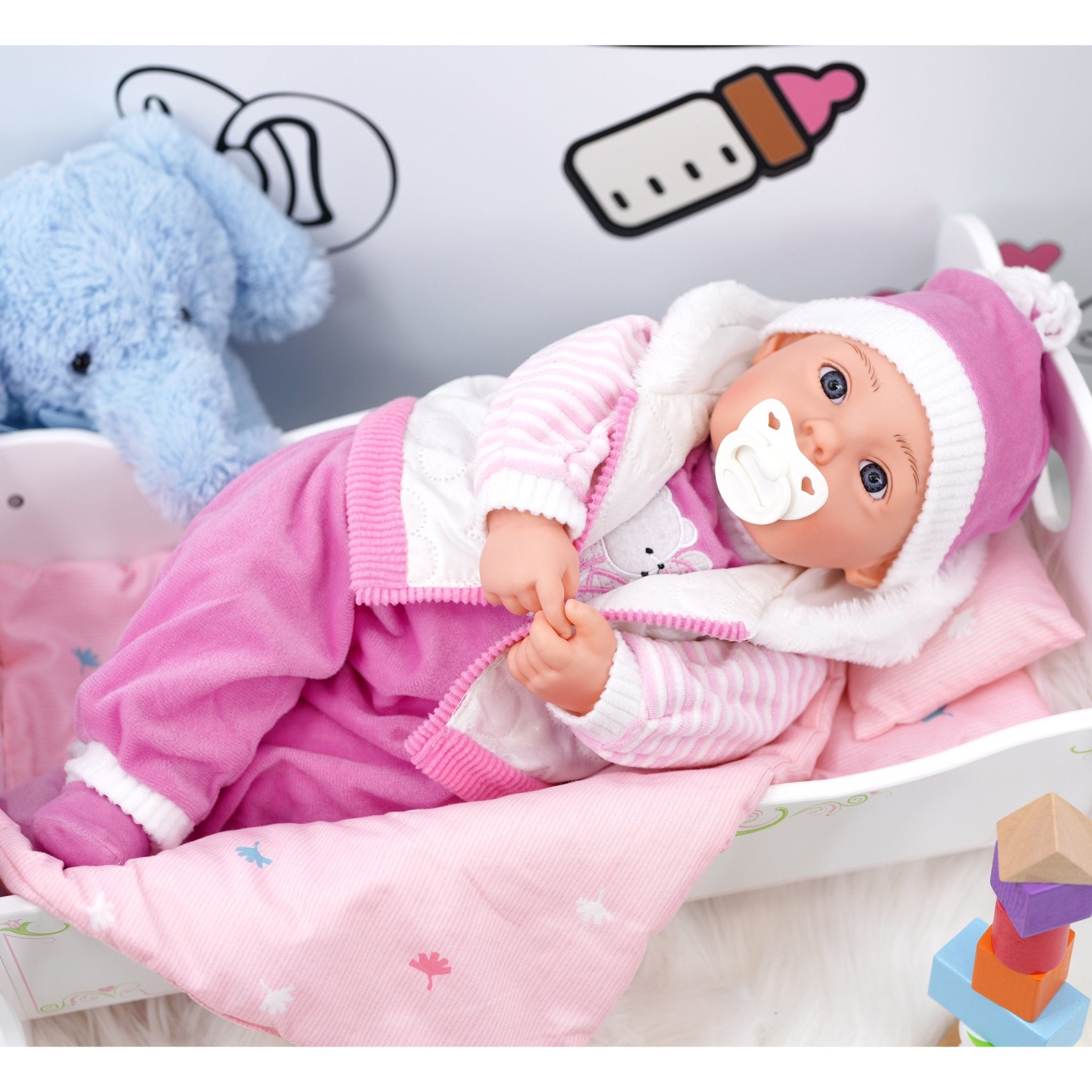 Baby doll with pacifier in crib - The Magic Toy Shop