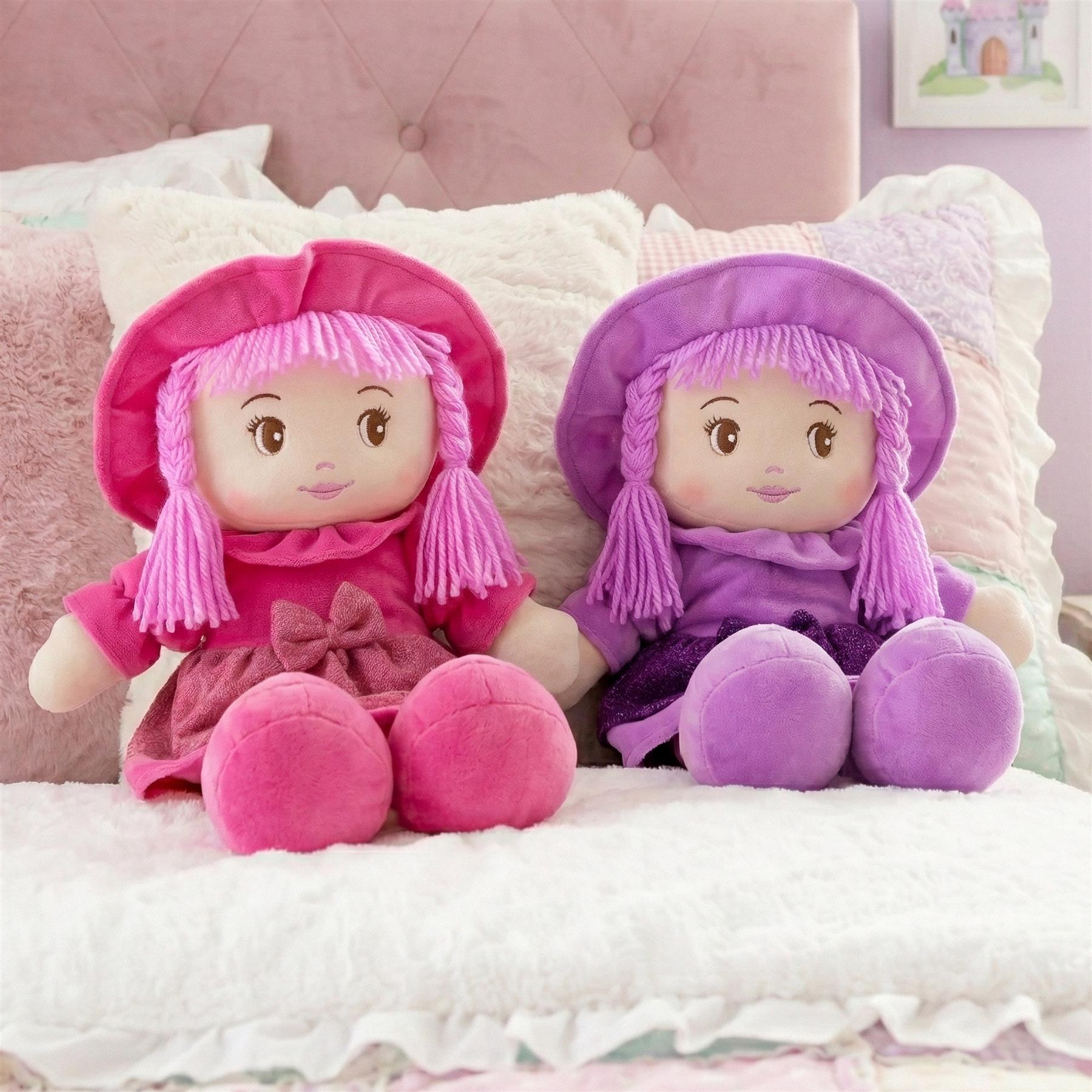 The pink rag doll, identified as Ruby, wears a matching pink bonnet and outfit.
