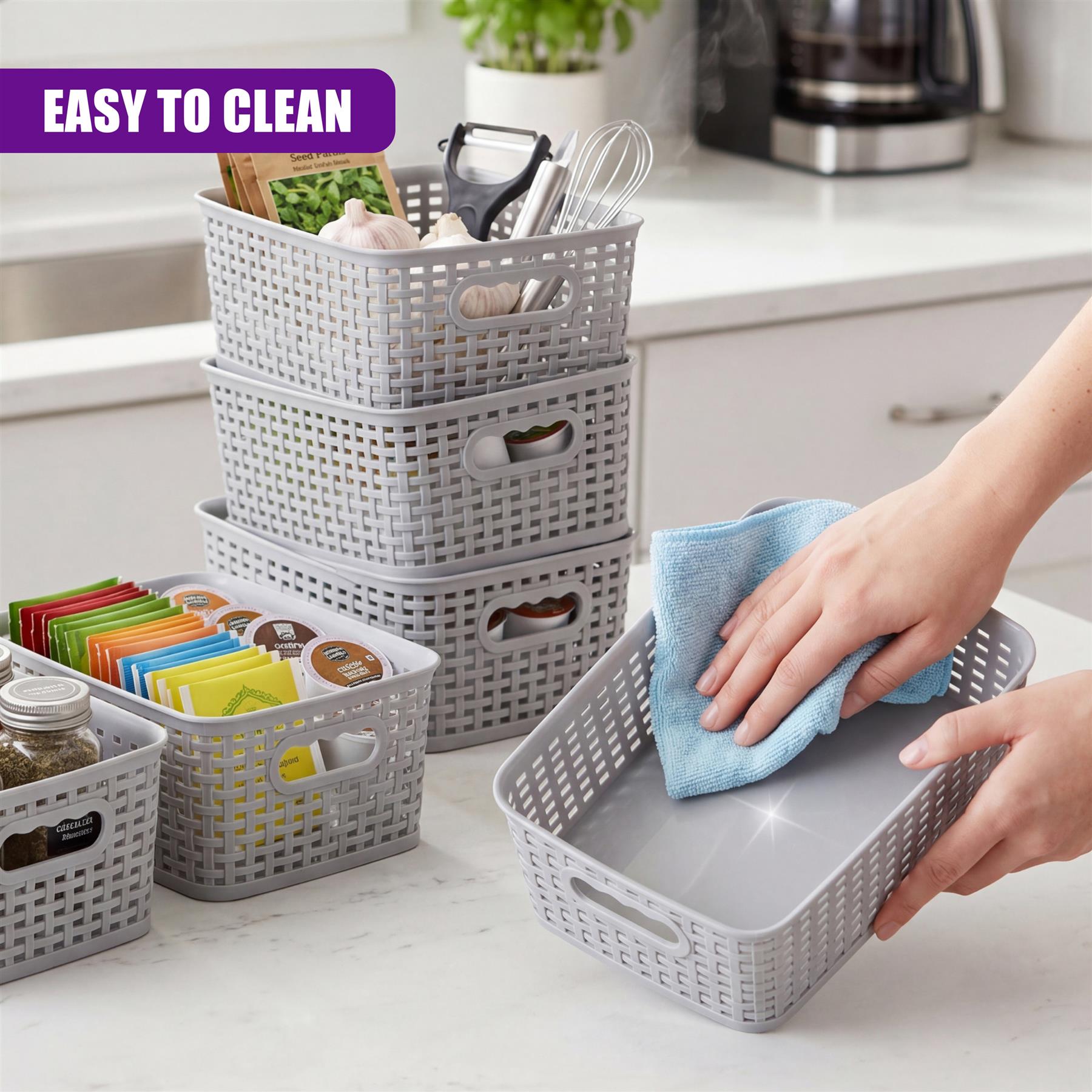 A hand cleans a shallow gray basket on a countertop filled with stacked storage baskets.