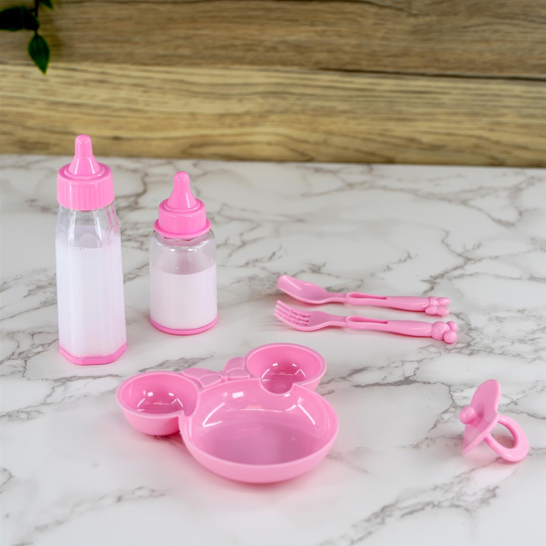 Pink plastic doll set containing two bottles, feeding bowl, and two small utensils.