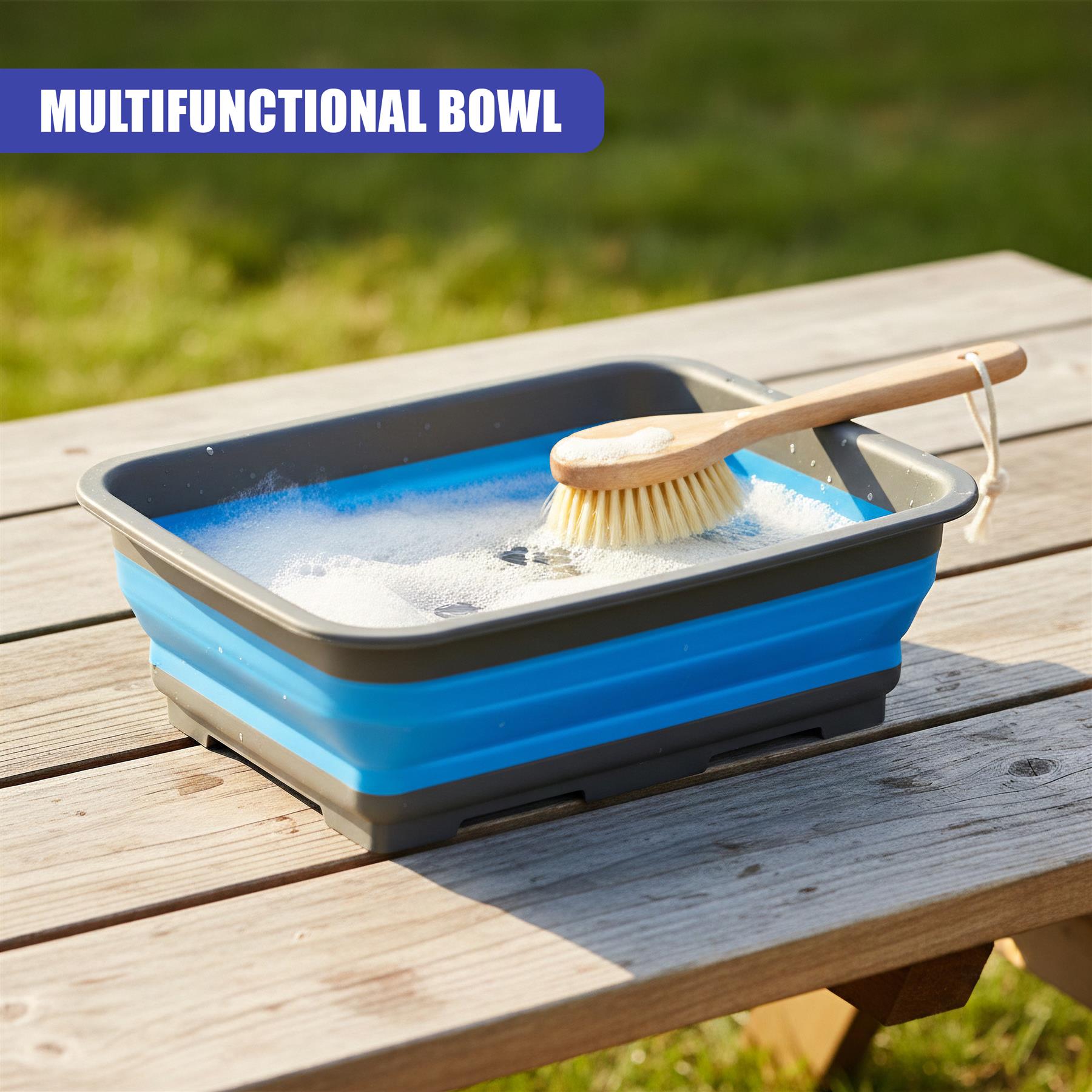 Collapsible blue washing bowl holding soapy water and a small scrubbing brush on wood.