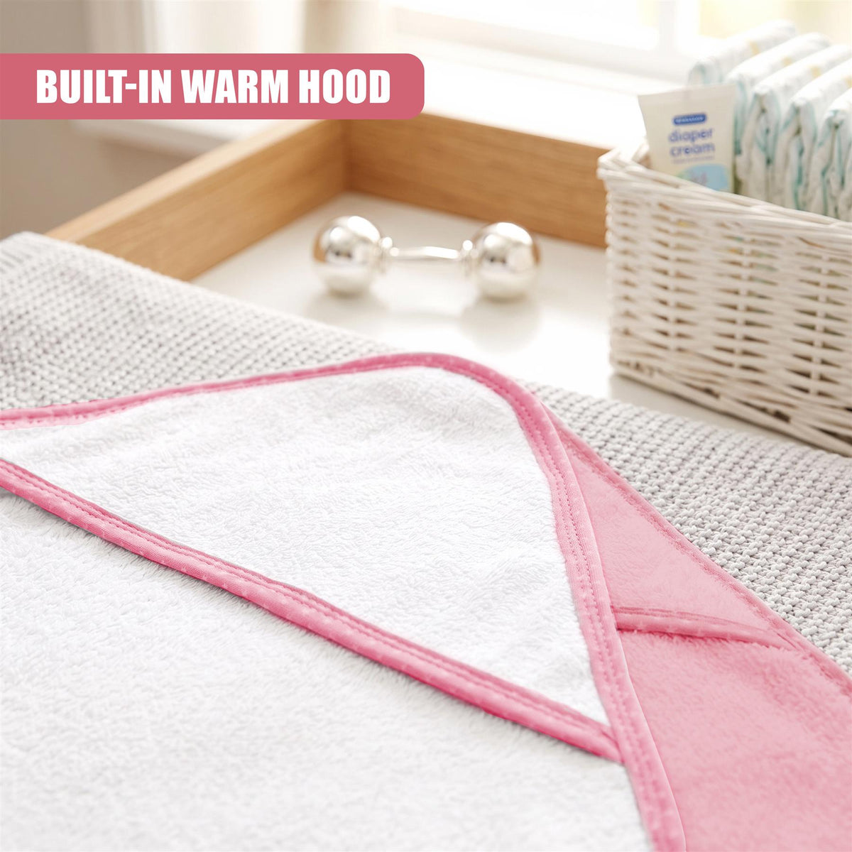 A pink and white hooded baby towel from GEEZY is shown in a product shot
