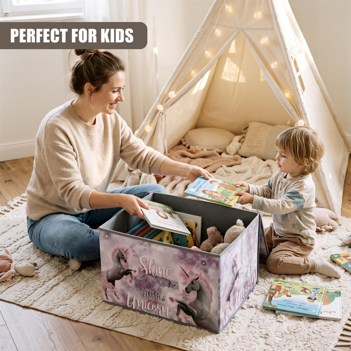 A mother and child are sorting books in a large, foldable unicorn storage box