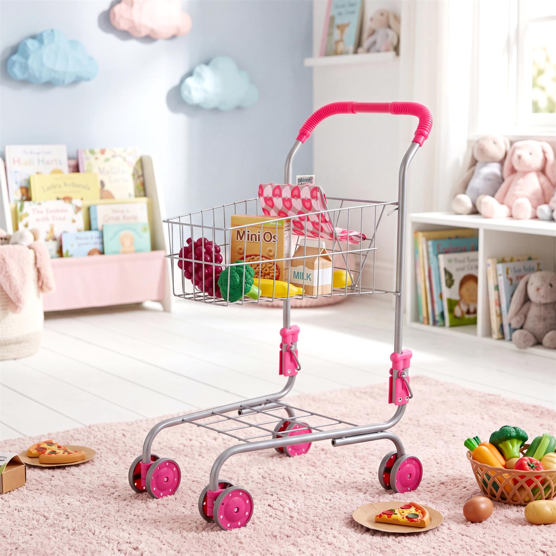 A metal shopping trolley filled with toy groceries, placed on a pink rug with other toys visible.