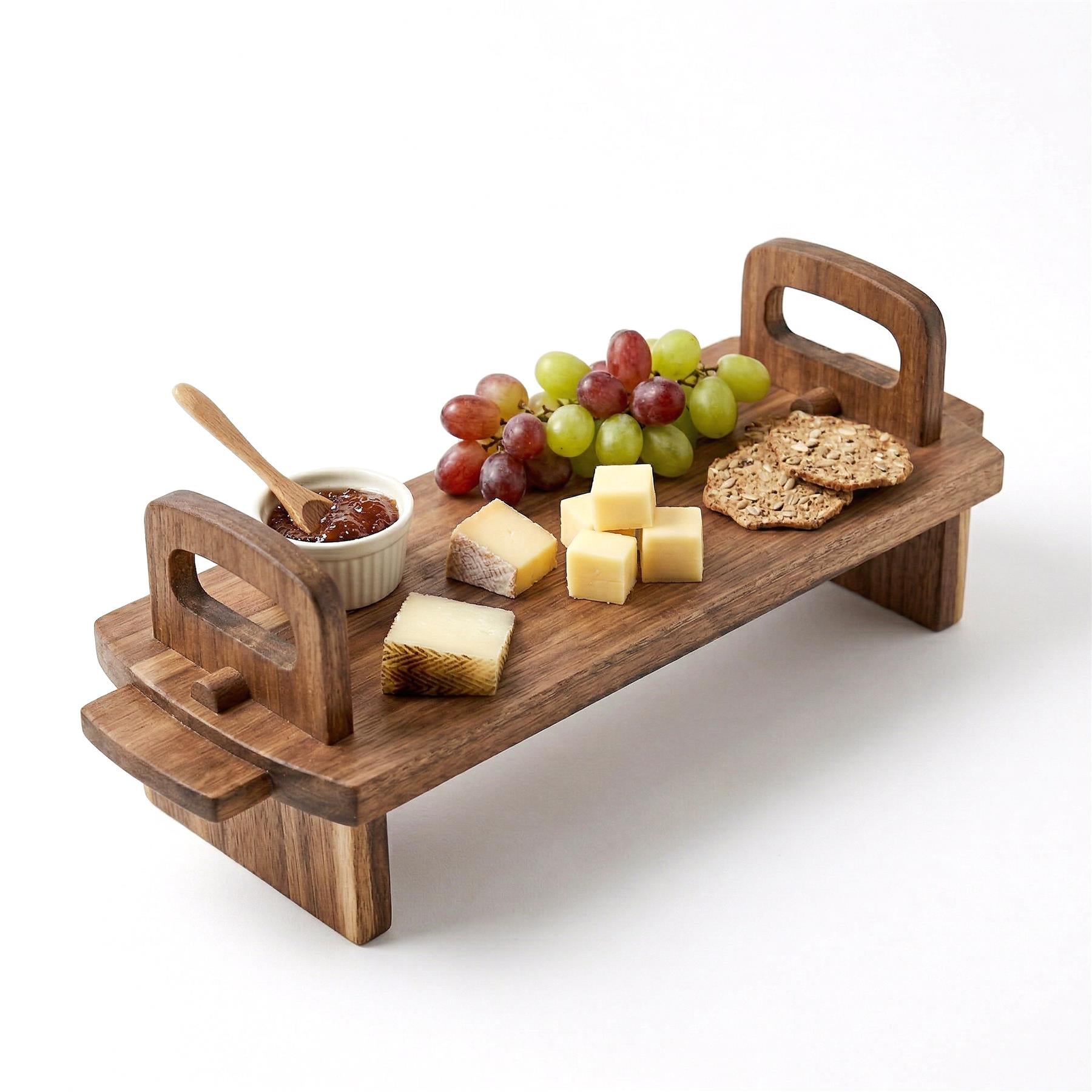 Serving platter filled with grapes, cheese cubes, crackers, and a dipping sauce.