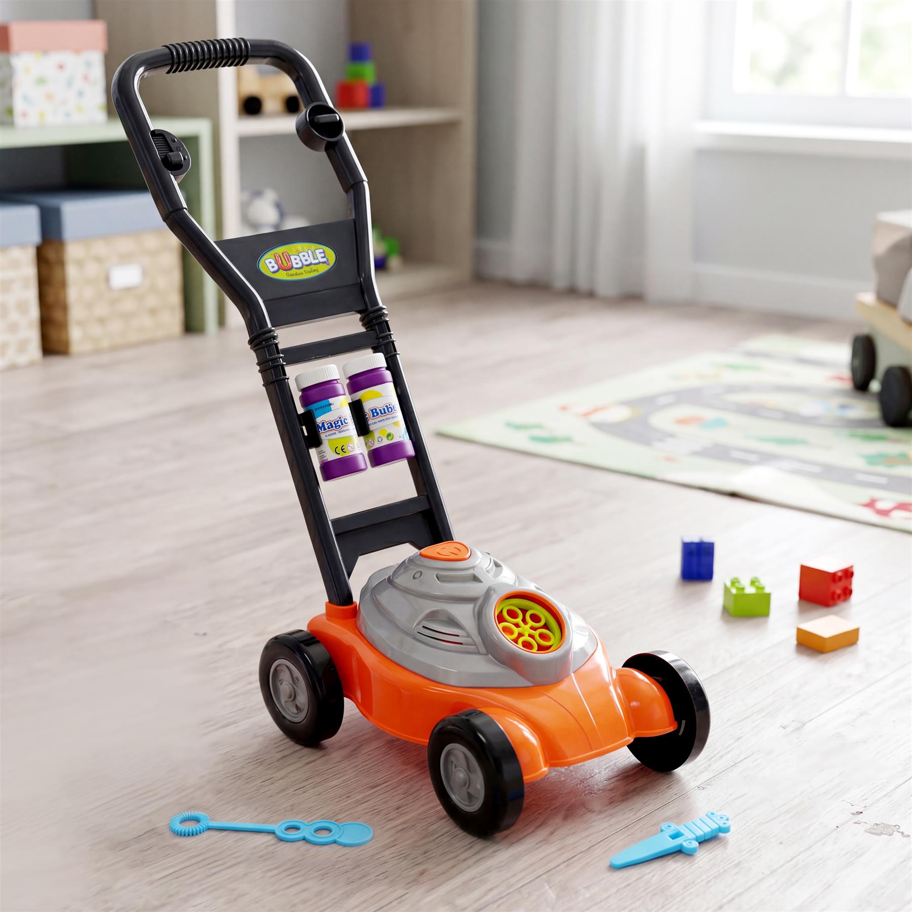 Orange bubble mower toy with attached soap bottles, accessories, and colorful plastic building blocks.