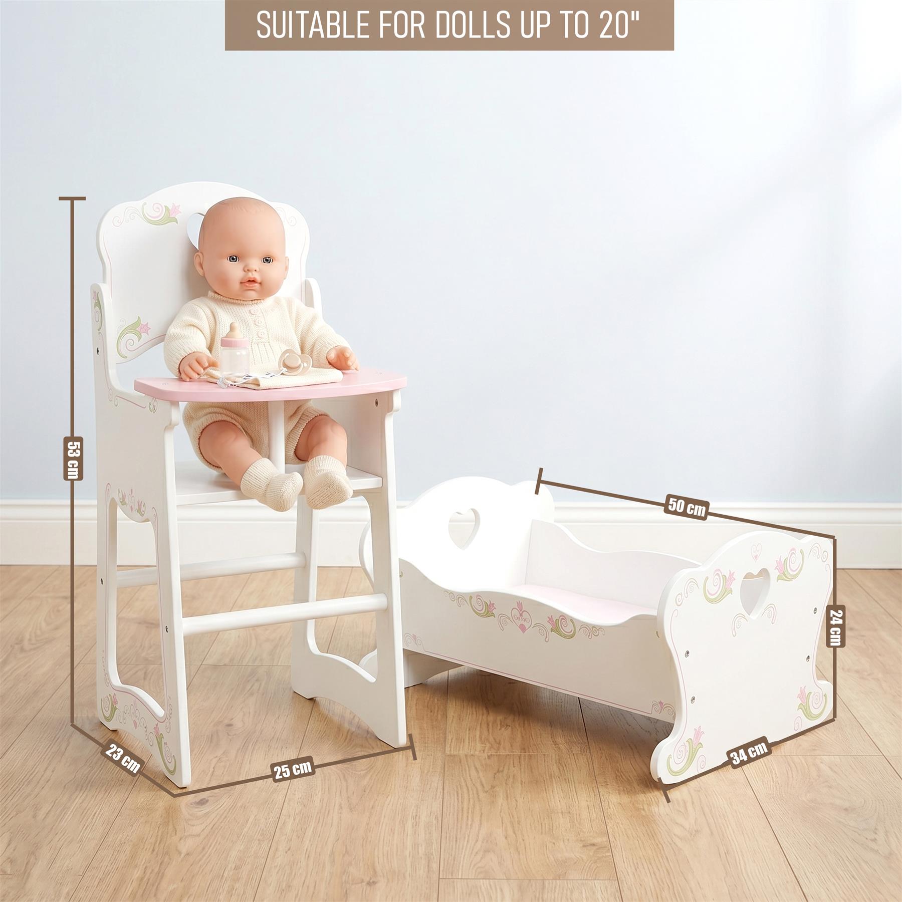 A white wooden doll's high chair and matching cradle set are displayed together on a floor.