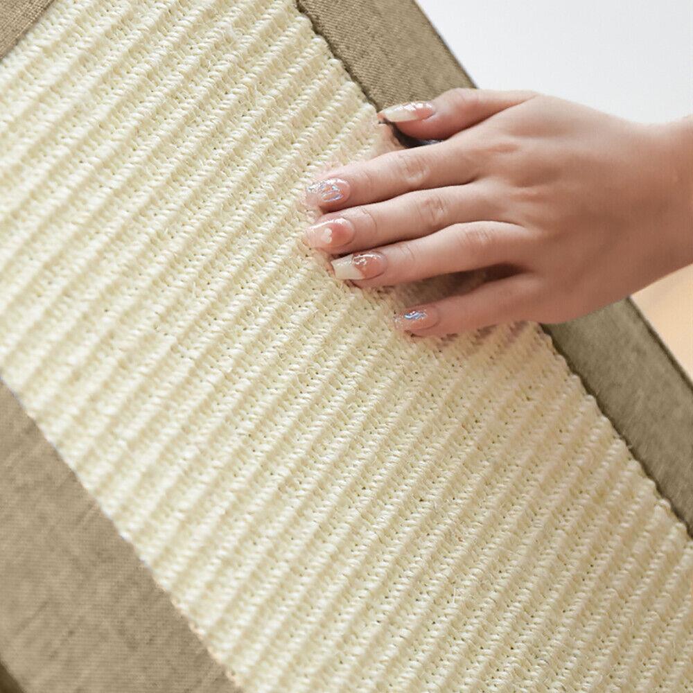 A hand with long, pale pink nails gently presses a soft, cream-colored rug with a textured, woven design, creating a warm and inviting atmosphere. - The Magic Toy Shop
