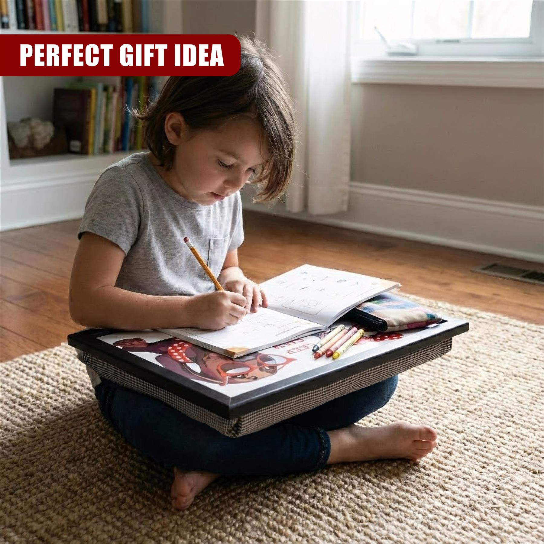 A girl writes at a patterned lap tray, which holds papers and writing utensils on a rug.