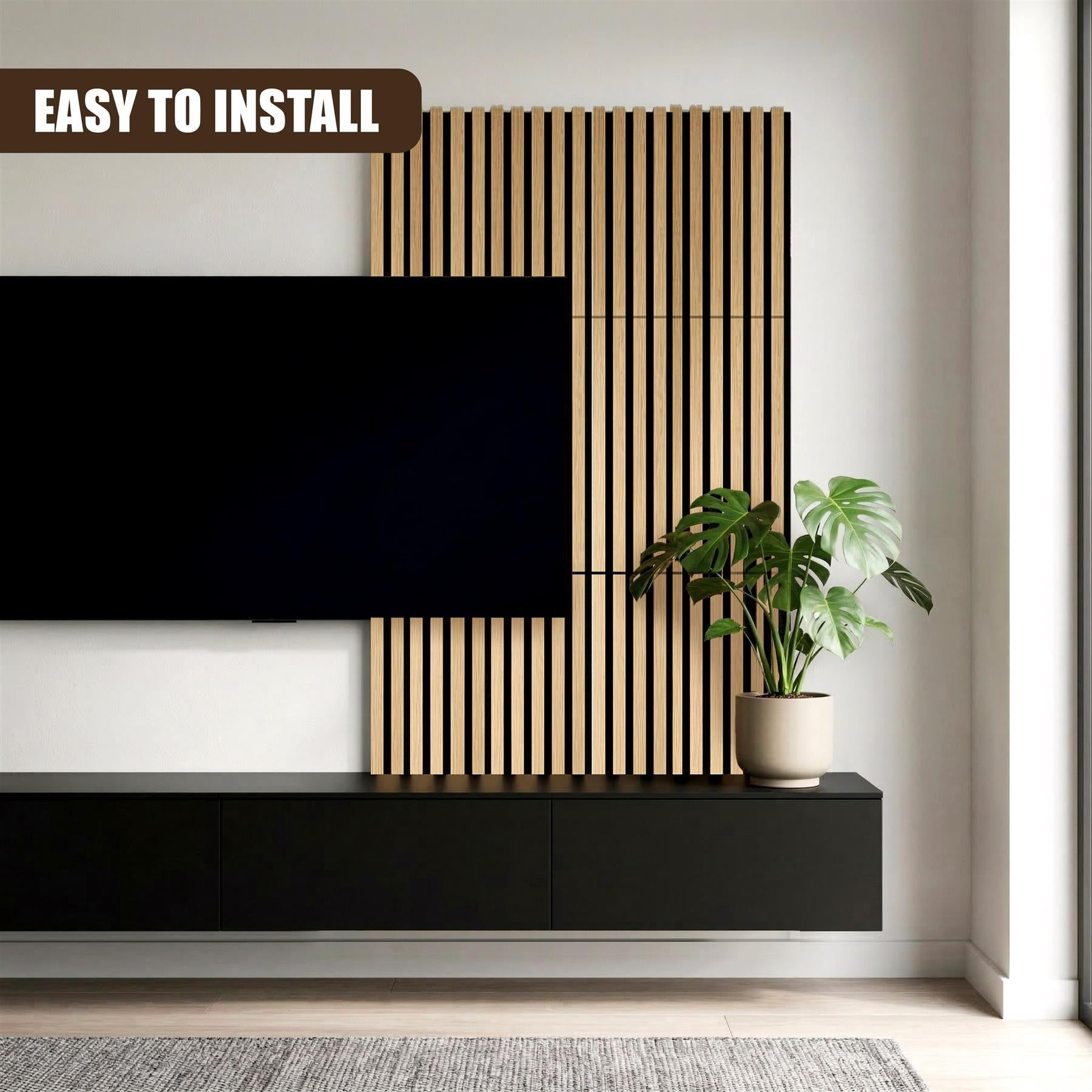 Vertical wooden slat wall panels are installed above a console cabinet next to a television and plant.
