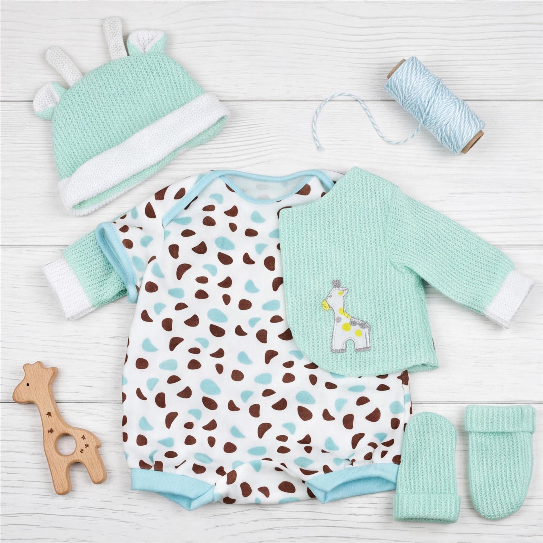 Newborn clothing set: spotted bodysuit, mint green jacket, hat, and pair of socks.
