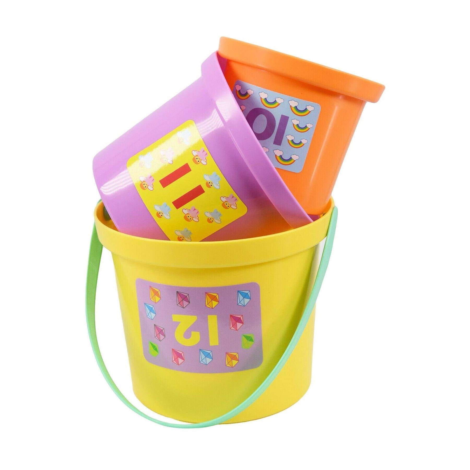 Stacking cup toy set featuring yellow, purple, and orange pieces with visible numbers and geometric shapes.