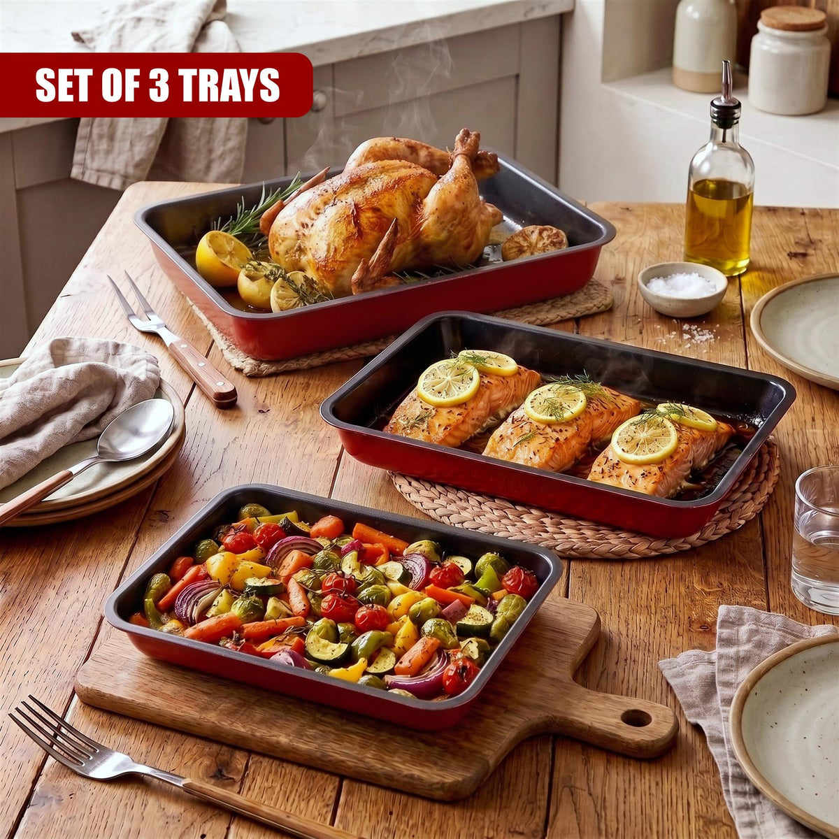 GEEZY set of three red non-stick roasting trays with vegetables and fish displayed on a wooden table