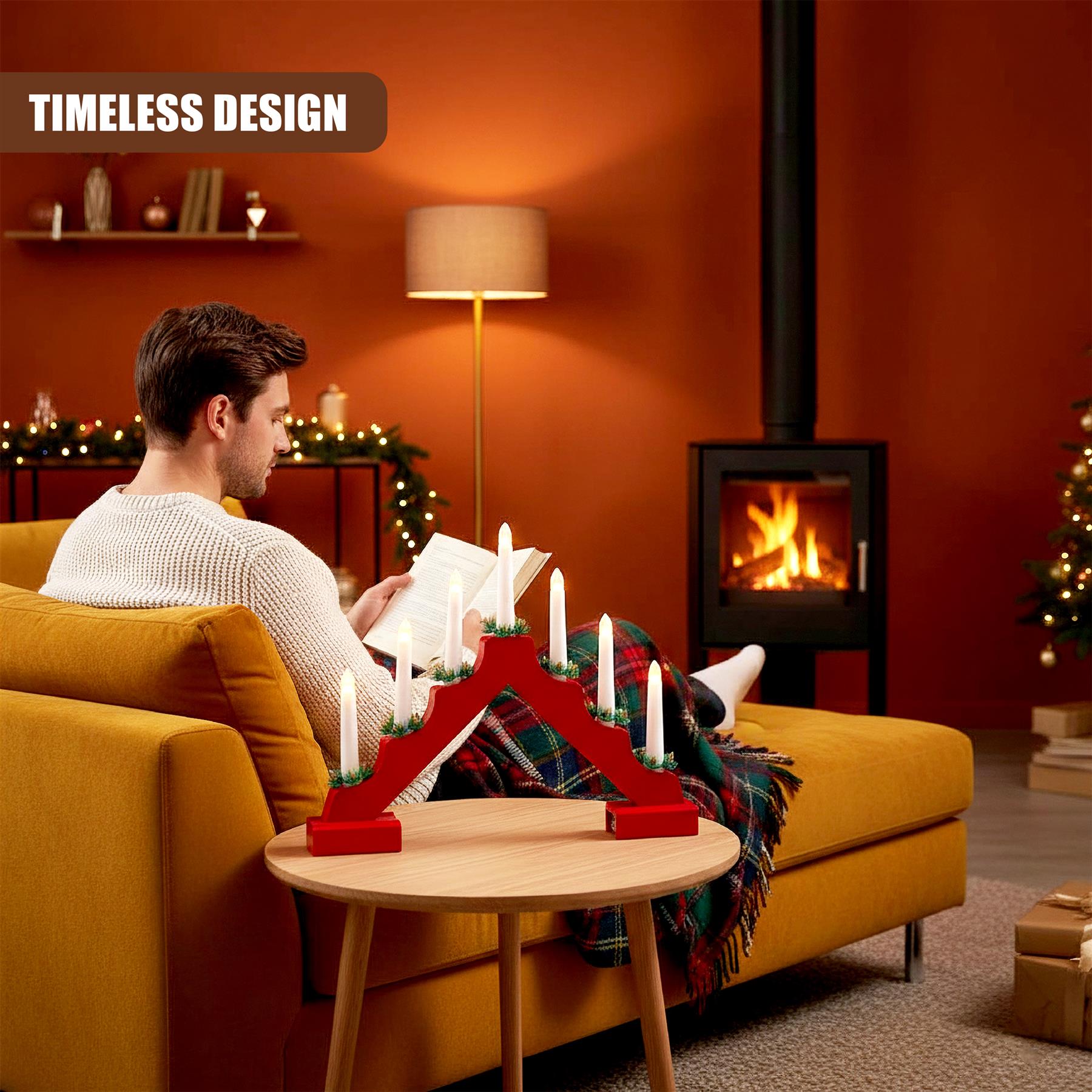 A man sits on a couch, holding a book, in a cozy living room. A Christmas tree is visible in the corner, and a fire is burning in the background. The room is decorated with festive lights and a red, wooden, candle holder with multiple white candles is on a nearby table. - The Magic Toy Shop
