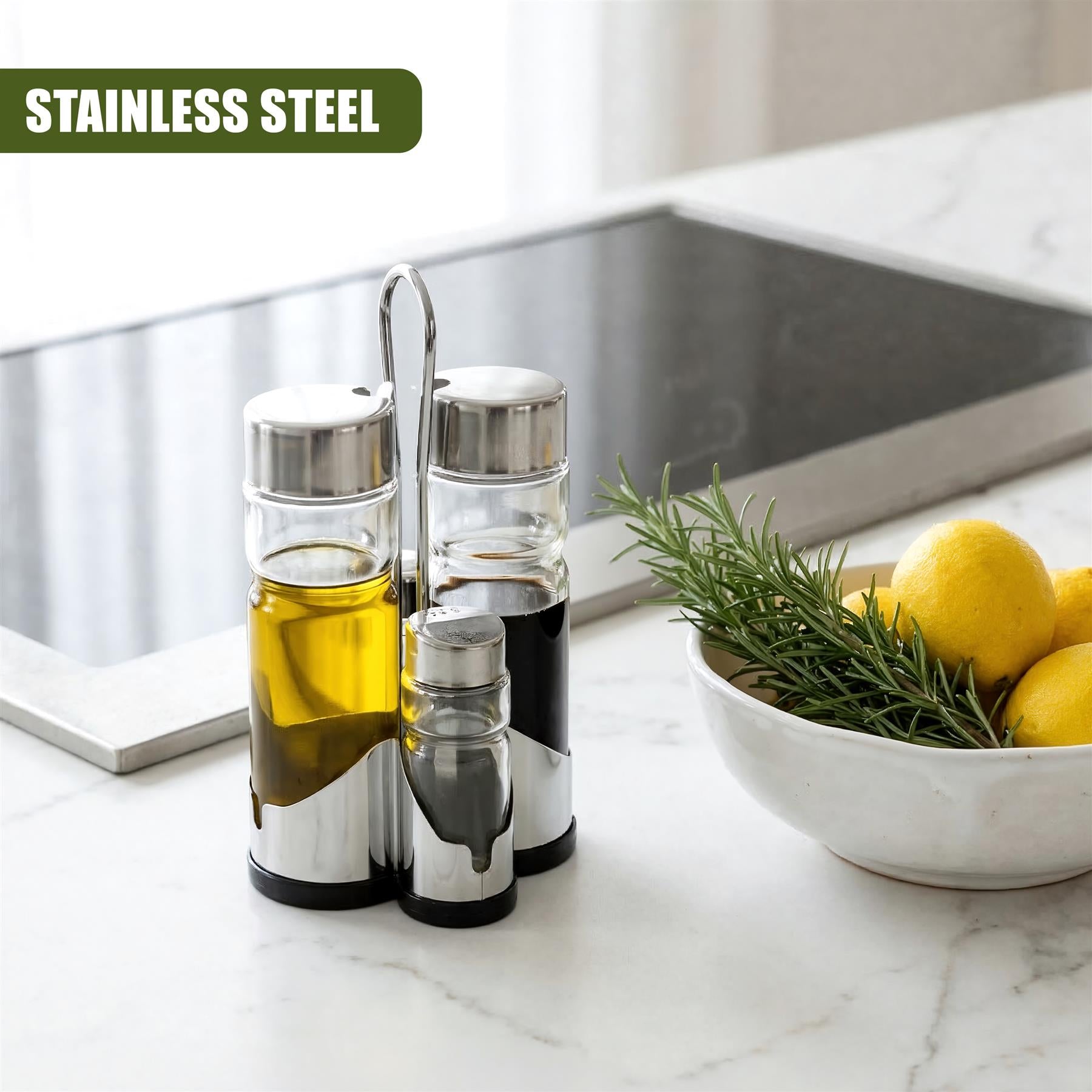 Four silver dispensers rest on a counter beside a white bowl filled with lemons and rosemary.