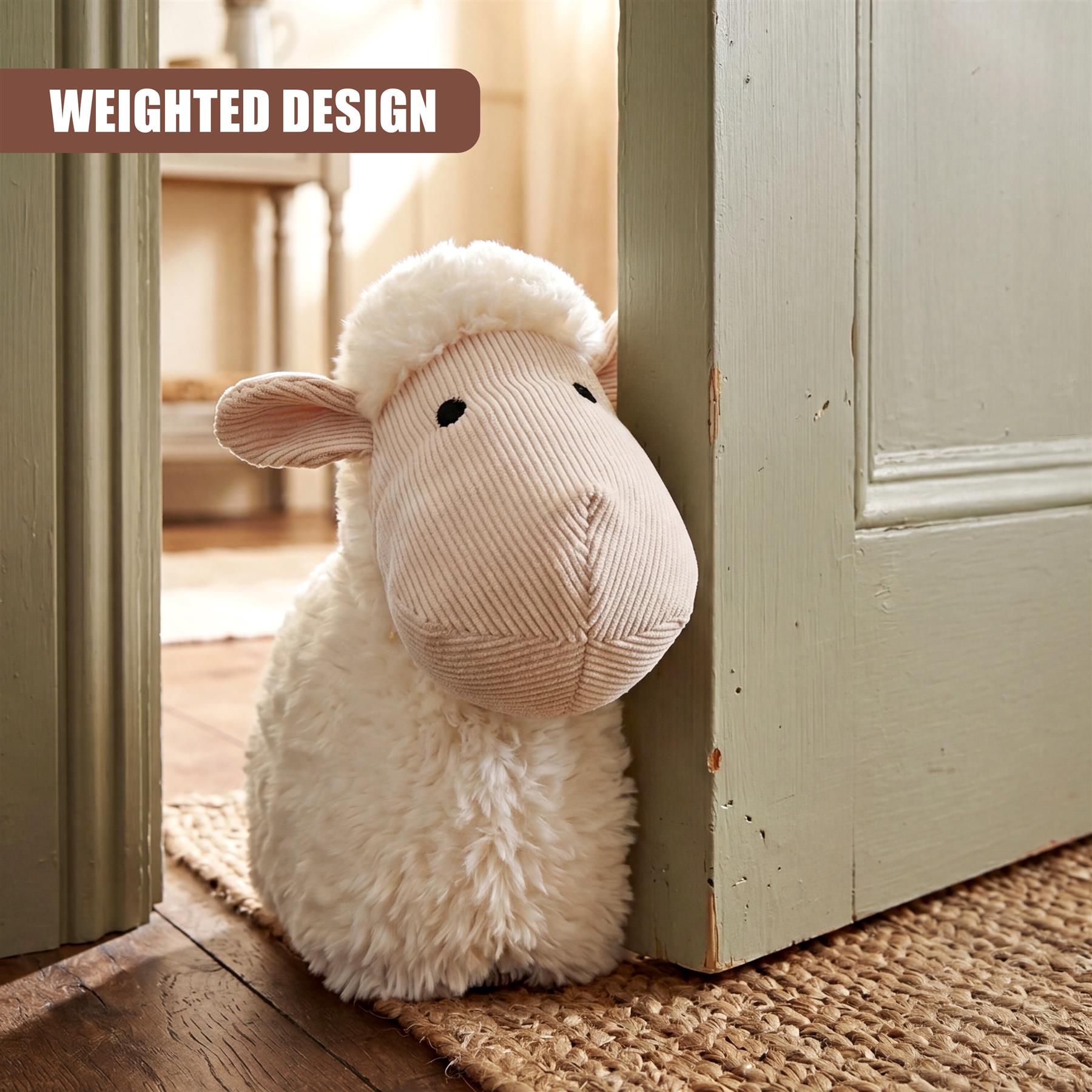 A fluffy sheep plush stopper rests against the jamb of a light green painted door.