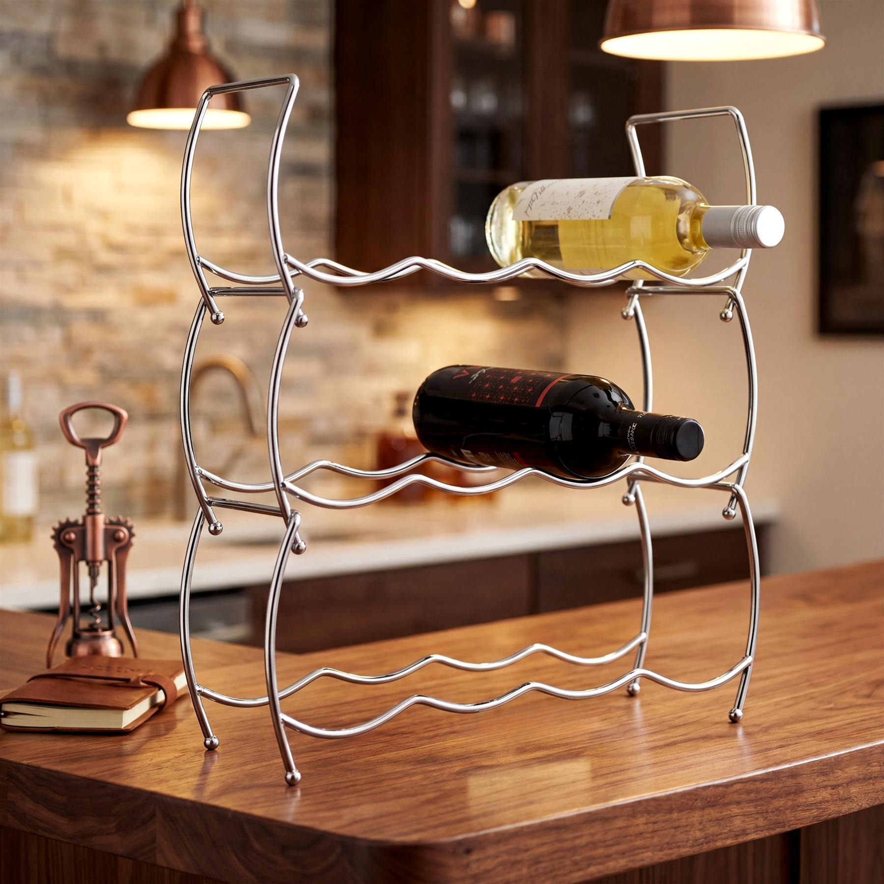 A scrolled metal, two-tiered wine rack holds several bottles on a wooden kitchen counter.
