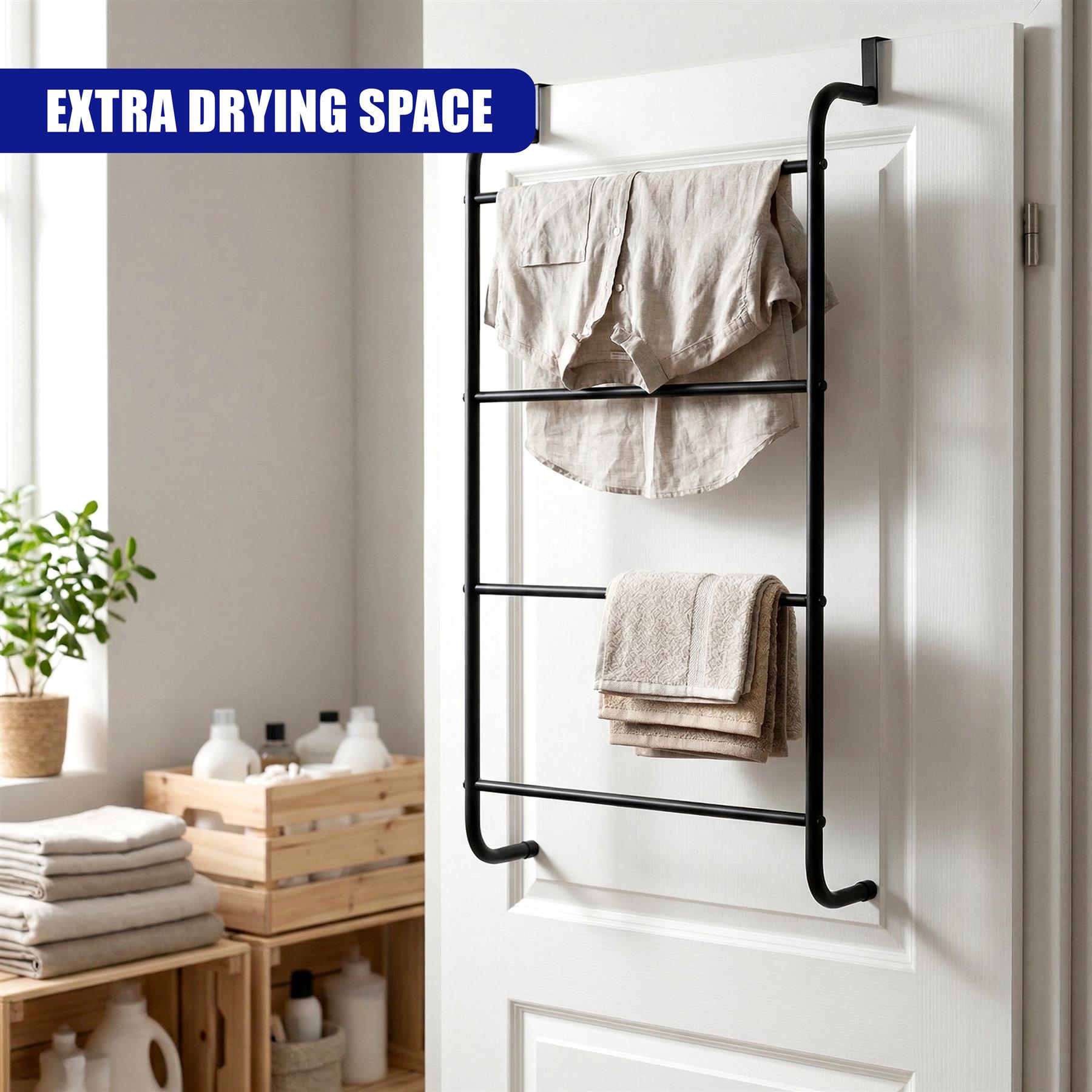 Black metal towel rail mounted to a white door, holding several folded bath towels.