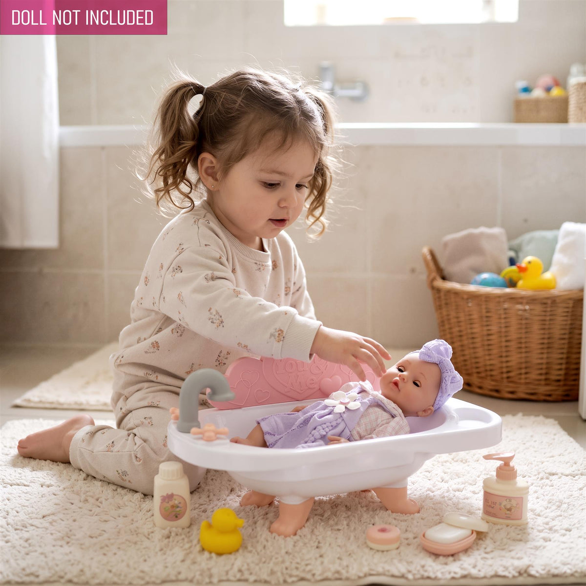 A child plays with a doll bath set including a bathtub and accessories