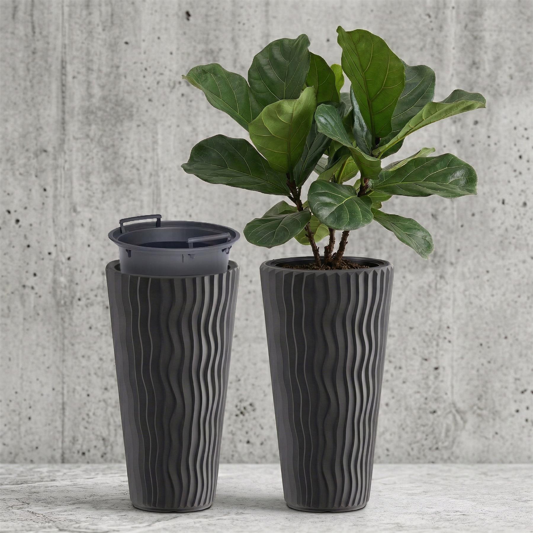 Anthracite tall fluted pot and matching container placed near a vibrant green plant.