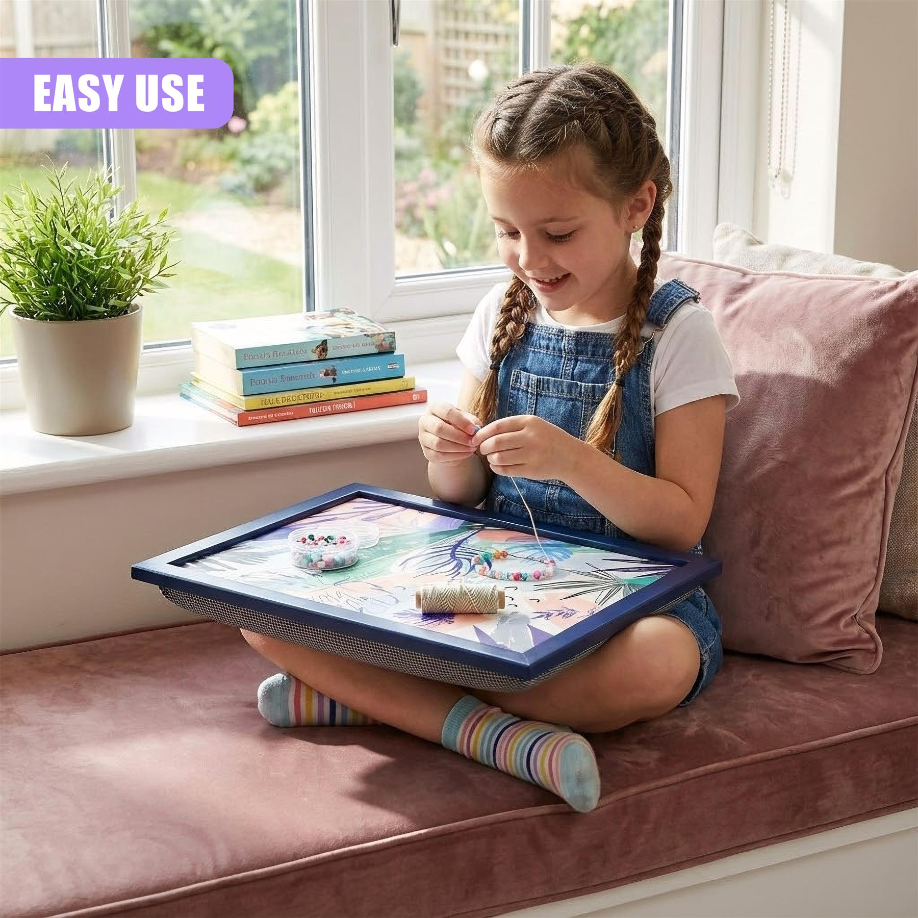 Girl crafts on blue lap tray featuring a tropical palm leaf design.