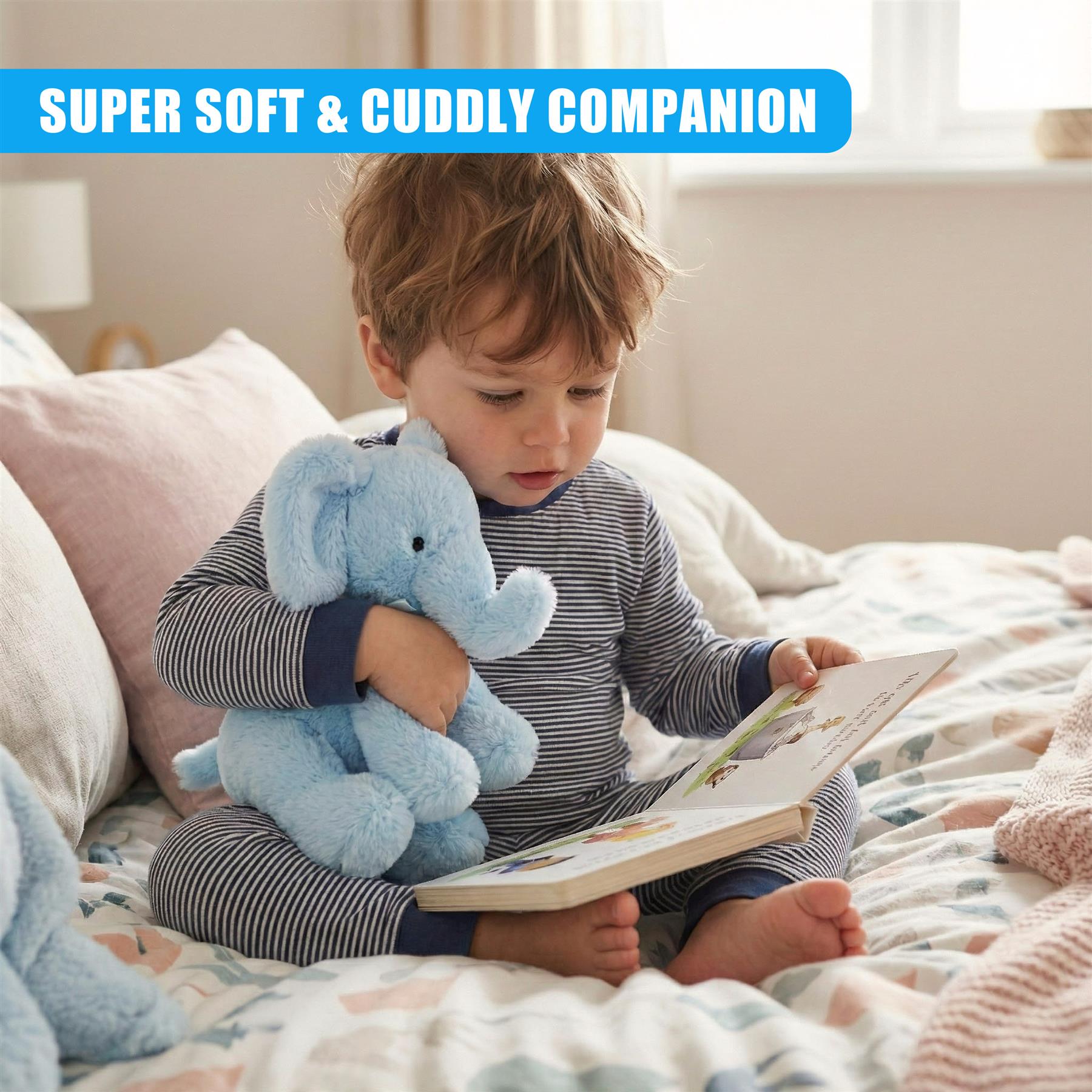 A young boy sits on a bed, holding a soft blue elephant plush toy and a book. The child's hair is messy, and he's wearing a striped onesie. The room is warm and sunny, with a window in the background. The boy's eyes are fixed on the book, and the elephant is held close to his chest. The bed is covered with a white and pink comforter, and a few toys are scattered around the boy. The room is cozy and inviting, with a few toys and books in the background. The boy's face is peaceful, and h… - The Magic Toy Shop
