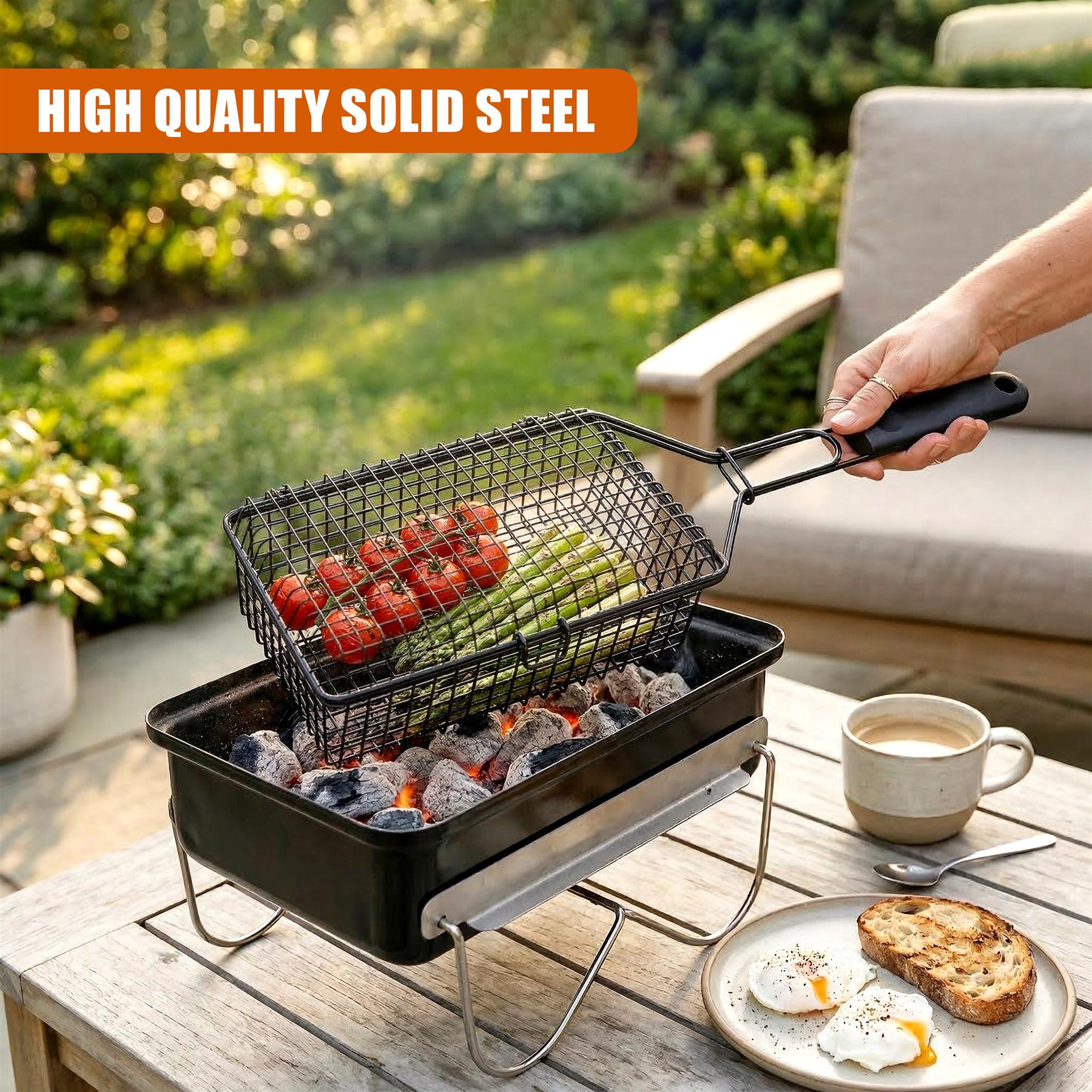 Deep grilling basket filled with strawberries and asparagus on an outdoor table.