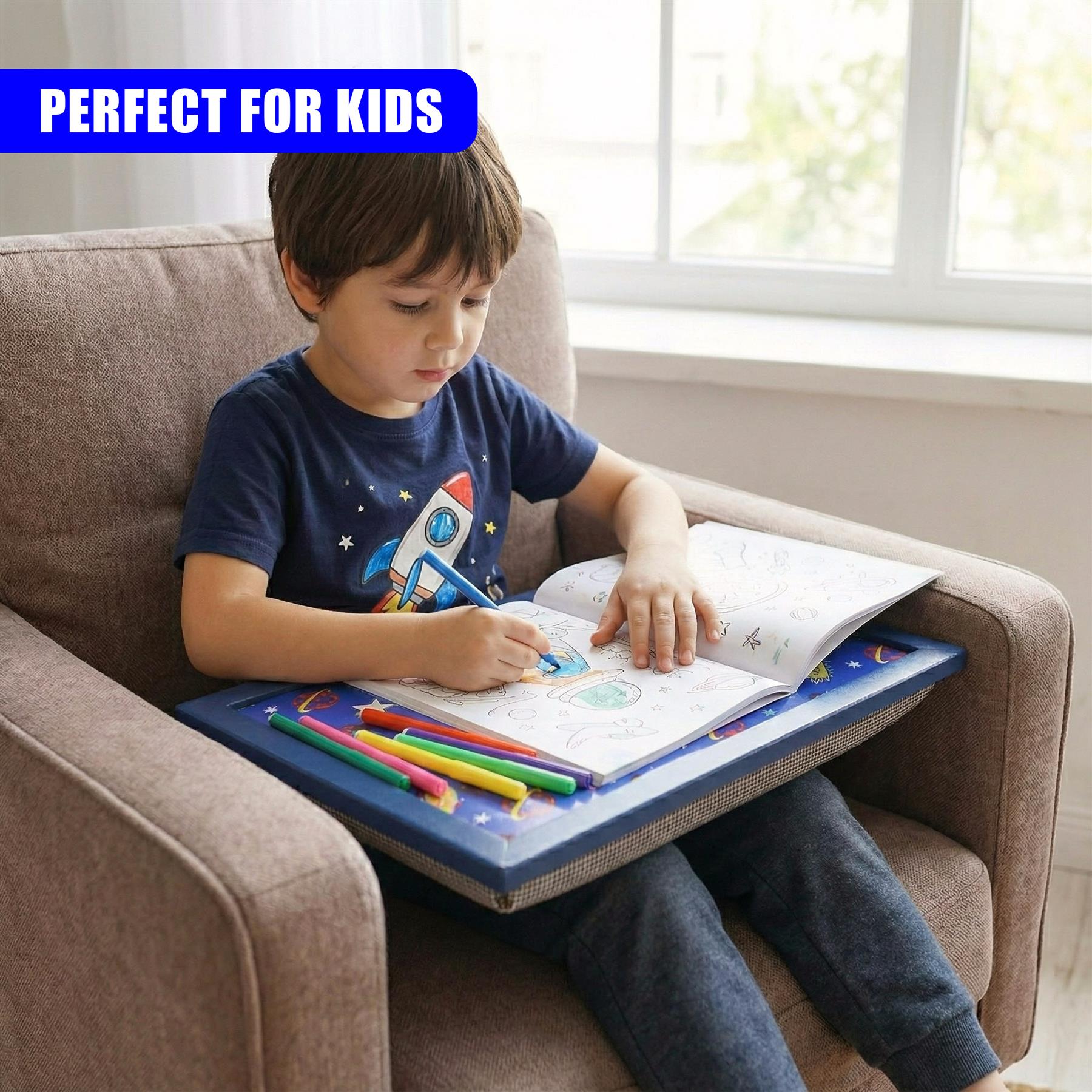 Boy drawing on papers placed on a blue rectangular lap activity tray with crayons.